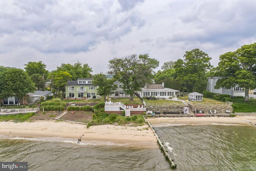 WATERFRONT ON THE CHESAPEAKE! Enjoy the endless water views from this immaculately kept home situated at the mouth of the South River and the Bay. Multiple decks provide ample seating to take in the views. Walk down the steps to the sandy beach. The exterior of the home was upgraded in 2016 with concrete board siding, new roof, new gutters, Weather Shield doors and windows, and maintenance free decking.  From inside, enjoy all the views through the casement windows that feature interior screens that roll up for clear viewing. When you want to enjoy those Bay breezes, simply roll them back down. There is a main level bedroom and full bathroom. Also on the main level is the kitchen with Kitchenaid stainless steel appliances, island, and eating area. All opening to the great room and all with water views. The second floor features the primary bedroom that is located on the rear of the home with unobstructed views of the Bay. A third bedroom, full bathroom, and laundry area with built-in cabinetry are also located on the second floor. Other details include recessed lighting (inside and out), crown molding throughout, custom blinds/shades/window treatments. Additional upgrades include new hot water heater (2023), Carrier heat pump system (2015), and complete water system that will convey as well. The community has its own boat ramp and pier that are in walking distance. Whether it’s a get-a-way home or your permanent residence, this is an amazing opportunity to wake up every day to these views.