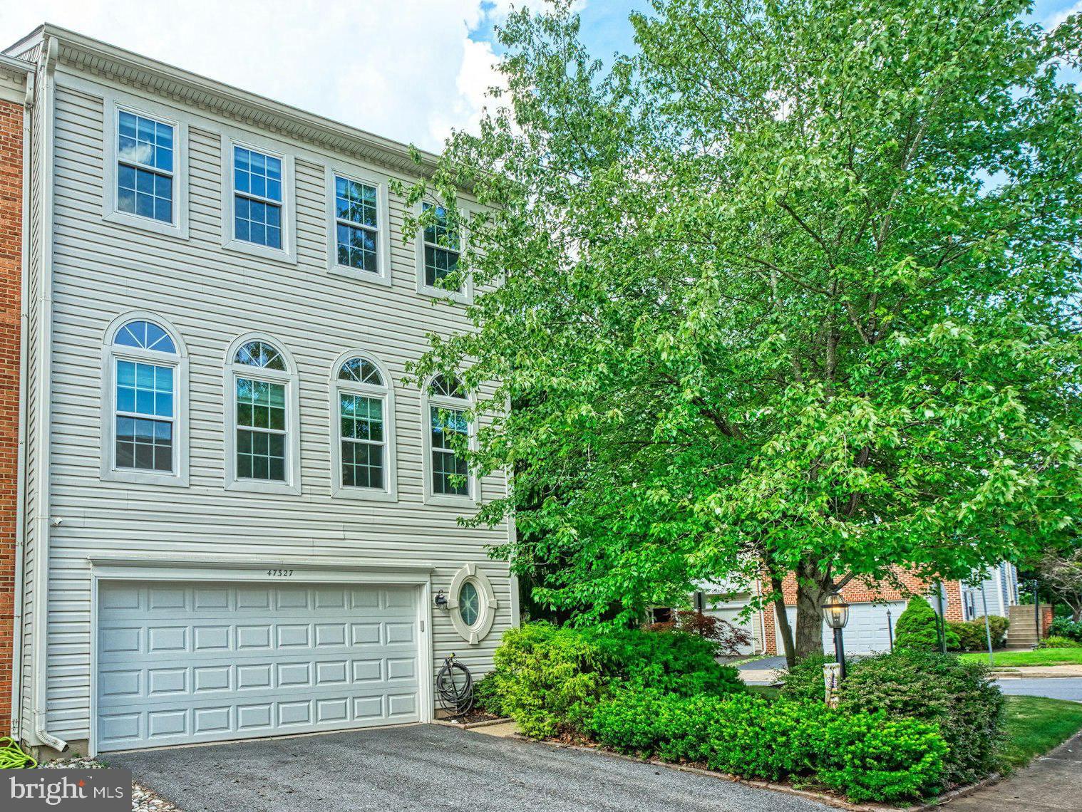 Welcome home to this tastefully upgraded & updated 2-car garage end unit townhome in convenient location. Custom paint, hardwood floors & upgraded lighting throughout. Inviting foyer features closet & powder room. Expansive living room with wall of windows provides tons of light & opens to the formal dining room with upgraded chandelier. Renovated kitchen with stainless steel appliances, upgraded countertops & spacious breakfast room. Luxurious primary suite featuring hardwood floors, walk-in closet with custom built-ins & spa like bathroom with oversized shower & dual vanity. The upper level features two spacious secondary bedrooms with hardwood floors & custom closets as well as upgraded second full bath & laundry room. Finished walk-out lower level with recreation room featuring fireplace, second powder room & storage. Spacious deck & lower level patio overlooking fenced rear yard. Oversized two car garage with custom floor too! Tos of other upgrades including new hot water heater in 2025 & more. The solar panels have been paid off & provide savings!
