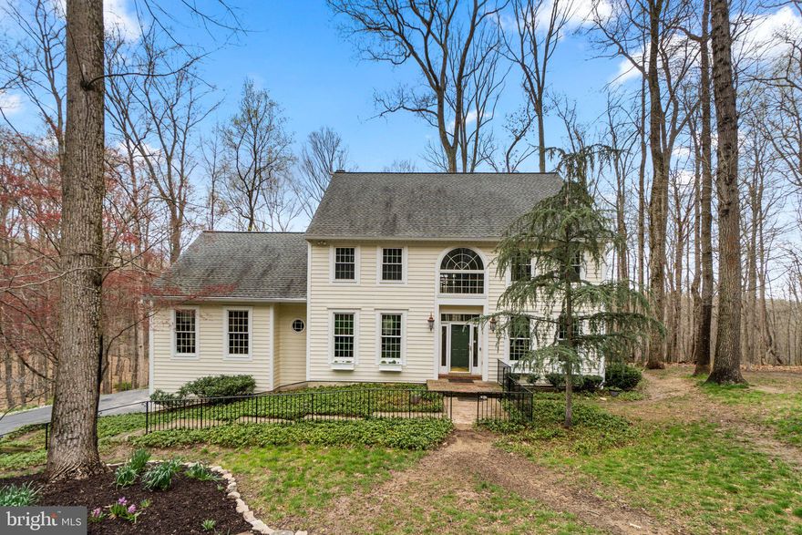 The perfect blend of luxury and function is embodied in this stately colonial nestled on a wooded 3.16 acre homesite presenting gleaming hardwoods, refined profile crown moldings, upgraded lighting, fresh interiors, an invisible fence, a 2-car garage with Poly-urea slip resistant flooring, and a 75K generator. Decorative trim and beautiful architectural angles are found throughout the 4,489 sqft home providing sophisticated places to entertain and enjoy. The impressive interior features a center hall entry, a formal living room with French doors opening to the family room, a second set of French doors to the sun-drenched formal dining room, and French doors to a private study with a vaulted ceiling and wooded views. Bask in the glow of abundant natural light in the family room displaying a marble surround fireplace, a wall of windows, and a walkout to the expansive deck with a hot tub and screened gazebo overlooking the private wooded landscape. Creative cooking will ensue in the chef's kitchen boasting both 42" glass and solid front wood cabinetry, granite counters creating a modern aesthetic, a center island with a JennAir cooktop and breakfast bar, a full appliance package including a Bosch dishwasher, JennAir wall and convection oven microwave, a SubZero side by side, a large pantry, and an open breakfast area with a bay window framing the tree-lined exterior. Comfort and luxury await in the splendid owner's suite presenting a vaulted ceiling, a walk-in closet, wooded views, a sitting area, and a private luxe bath displaying a skylight, a dual sink vanity, a separate shower, and two windows surrounding an oversized jetted tub. Offering plenty of space and flexibility, the lower level includes rec room, a second kitchen and dining area with LVT flooring, a built-in Murphy bed with installed shelves and drawers -- ideal as a studio apartment, In-law or Au Pair suite -- and a walkout to the yard. This desired Howard County location is close to commuter routes, shopping, dining, entertainment, recreation, and more!  Also, just a mile down the street, this neighborhood has access to the beautiful Patapsco State Park, with miles of hiking trails along the Patapsco River, the perfect place to enjoy the great outdoors whether hiking, biking, fishing, tubing, or kayaking.  A 1-year Home Warranty is provided by the Seller to the Buyer.