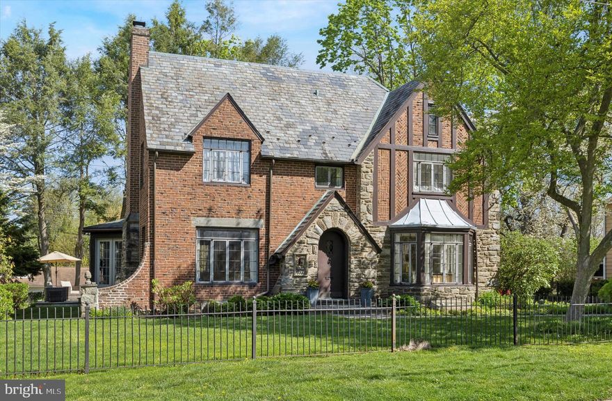 Welcome to 111 E Dartmouth, a thoughtfully updated Tudor-style colonial, located on the coveted Main Line in the Lower Merion School District, and offering close to 3000 sq/ft of comfortable living space. Enter into the classic foyer with gorgeous hardwood floors that continue throughout. The formal living room makes a wonderful first impression with a beautiful & functional wood-burning fireplace w/ marble surround and stately wooden mantlepiece. Across the foyer, the dining room w/ bow windows has been opened to the kitchen, creating a perfect space for dinner parties and family gatherings. The updated kitchen boasts floor-to-ceiling cabinetry, tile backsplash, concrete countertops, and high-end stainless steel appliances including a new Dacor refrigerator w/ pull-out snack drawer, built-In microwave, two ovens, push button raising range, six-burner gas stovetop, and dishwasher. A stunning sunroom addition by Gardner Fox with access to the back patio, is flooded with natural light and provides yet another splendiferous place to gather. An additional room, currently being used as a den w/ a closet and its own full bath, can easily serve as an office, first floor primary suite, guest bedroom, playroom, or au pair/in-law suite. A half-bath completes the first level. Head upstairs to find the primary suite with beautiful built-ins, double closet, and a full bath with seamless glass shower and vanity for storage. 2 additional bedrooms share a Jack-and-Jill bathroom, and an additional room accessible through one of the  bedrooms, has another full bath w/ a charming clawfoot tub and a closet. Head back down to the partially finished basement providing more flexible living space, a second wood-burning fireplace, and additional storage. Out back, the slate patio off the aforementioned sunroom overlooks the yard and offers the perfect place to dine al fresco and entertain in the warmer months. This gem of a home is located in the sought after College Park neighborhood with easy access to Rt. 76, City Ave, Manayunk, and downtown Philadelphia. Enjoy local shopping & dining, and all that Bala Cynwyd has to offer. You don’t want to miss the chance to call this house your new home!