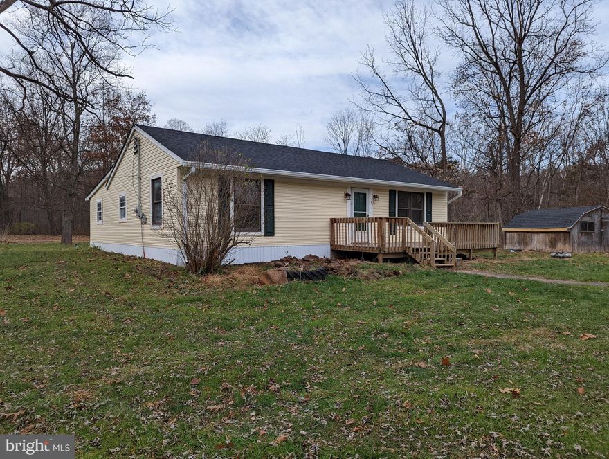 Thinking about moving to the country, or just looking for a get-a-way?  Check out this cozy rancher in North River Run.  Nice 2.16 acre corner lot, cleared and level.  Easy access to the 8,000-acre North Mountain Hunting Land and within walking distance to river.  Large wood stove heats the entire house.  Cozy up in front of the propane fireplace on those chilly evenings or on those warmer evenings, sit out on your deck and enjoy the peaceful setting.   House features a large family room with wood stove and outside access. Huge kitchen has ample cabinet and counter space and has a pass-through window to both living room and family room.   House features a newer architectural roof and fresh paint.  Call today for your appointment to see this adorable county home. House is eligible for USDA 203K to add a permanent heat source!