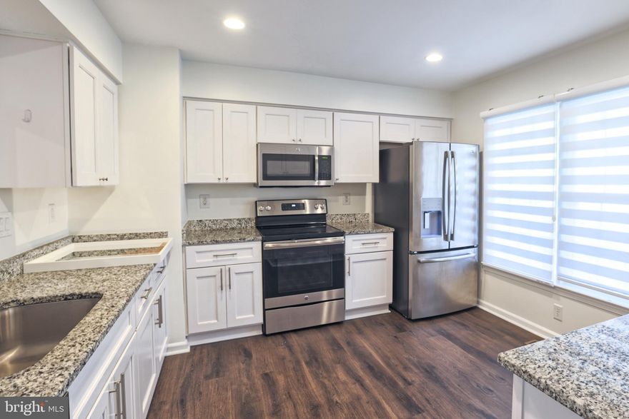 Back to Market ! FULLY REPAINTED NOW . .Move-in ready three-level townhouse! This stunning home is ready to welcome you. Enjoy peaceful moments on the covered front porch or the spacious upper deck overlooking a serene wooded view. Inside, the main level shines with a remodeled kitchen featuring granite countertops, white cabinets, stainless-steel appliances, and a brand-new dishwasher. A separate dining area, half bath, and bright living room with deck access make entertaining a breeze. Upstairs, the primary suite offers vaulted ceilings, a walk-in closet, and a private ensuite bath, while two additional bedrooms and a full bath complete the upper level. The lower level provides the perfect retreat with a large family room featuring a corner fireplace, a full bath, laundry area, extra storage, and walkout access to the fenced backyard and lower deck. Recent upgrades include a brand-new HVAC system, new water heater, new dryer, and new dishwasher. Two assigned parking spaces are located right in front of the home, with ample visitor parking available. Enjoy community amenities including a lake, beaches, pool, golf course, parks, bike and jogging trails, picnic areas, and tennis courts. Conveniently located near I-95 and Route 234, this home offers the perfect blend of comfort, convenience, and community. Schedule your tour today!