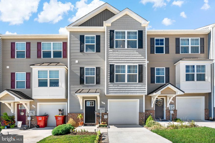 This modern townhome in the Communities of Burwell is sure to wow! Walk in on the basement level complete with  a bedroom and a full bath, perfect for a guest room, full office, or however you see fit! The main level features a gorgeous kitchen with upgraded cabinets and countertops and a spacious open concept, perfect for relaxing and entertaining. Upstairs you'll find 3 bedrooms and 2 more full baths, including the owner's suite with walk-in closet, double vanity, and tile shower. Just built in 2021, this home still shows like new and is move-in ready!