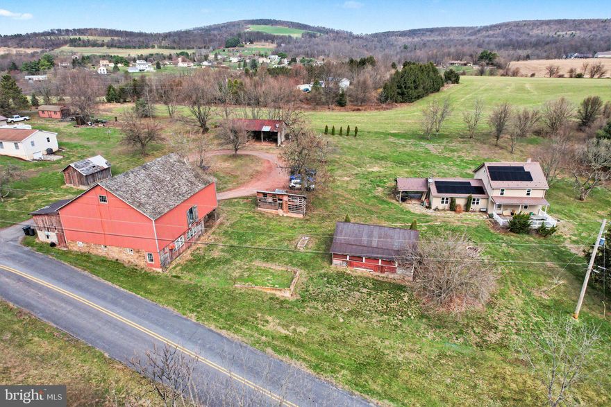 Welcome to this beautiful 4+ acre country property offering the perfect blend of comfort, functionality, and peaceful rural living. Featuring a pond, a spacious barn well-suited for housing animals, and multiple outbuildings, this property is ideal for those looking to start a homestead, create a farmette, or simply enjoy extra space and privacy.

Enjoy stunning country views in every direction and frequent wildlife sightings right from your own backyard—adding to the peaceful, nature-filled setting this property offers.

The pond provides a nice focal point and a relaxing outdoor spot to enjoy the scenery.

Relax and take in the scenic surroundings from the large covered front porch or entertain with ease on the spacious covered side deck—perfect for grilling and enjoying the quiet countryside.

Inside, you’ll find an open-concept layout connecting the kitchen, dining, and living areas, highlighted by a pellet stove that serves as an efficient primary heat source. The main level also offers convenient first-floor laundry and a spacious primary suite complete with a walk-in closet and full bath.

Upstairs, there are two additional bedrooms and a full bathroom, providing comfortable space for family or guests. The home is equipped with four mini-split systems (two on each level) for added comfort, along with solar panels to help offset energy costs.

Located in unzoned Wayne Township, this property offers flexibility for a variety of uses. Enjoy the best of both worlds with a private, country setting just minutes from the Halifax shopping plaza and an easy 30-minute drive to Harrisburg.

Don’t miss this opportunity to own a versatile property with endless potential!