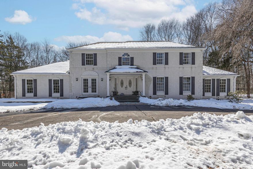 Set within a private and secluded setting, yet just two miles from I-95 and minutes to both the Trenton and Yardley train stations, this exceptional residence offers the perfect balance of tranquility and convenience.  A long, winding driveway leads to a gracious well maintained 4 bedroom, 3.5 bath center hall colonial. Enter through a set of double doors to find to a stylish curved staircase and hardwood flooring mostly throughout.  The first level features a bright spacious formal living and dining room. The spacious eat-in kitchen offers abundant cabinetry, granite countertops,  stainless steel appliances, and an island with counter seating.  Connected to the kitchen is a sun-drenched sunken family room with a gas fireplace.  There are  walls of glass and French doors that extend to the backyard patio, perfect for entertaining or quiet relaxation. The first floor also includes a bedroom with a full bath and a private exterior entrance, perfectly suited for in-law or nanny accommodations. The main level is also complete with a half bath and direct access to a four-car side-entry garage. Upstairs, the primary suite offers a serene retreat with a sitting room, a spa-inspired bath featuring a soaking tub, and a generously sized, professionally organized walk-in closet.  A large hall bath is shared by two additional spacious bedrooms, one of which has its own sitting area.  The unfinished basement offers plenty of storage and closet space. The landscaped grounds showcase mature trees and thoughtfully designed plantings, enhancing the home’s sense of privacy and natural beauty.  Don’t miss the opportunity to make this exceptional move-in ready home yours—and within the award-winning Council Rock School District.