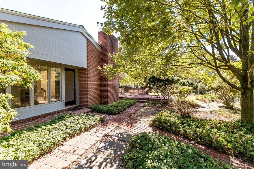 This authentic mid-century modern rancher has been beautifully refreshed to showcase its WALLS OF GLASS that have been designed to bring abundant natural light and nature IN! While maintaining many fantastic original features, this home now offers BRAND NEW: hardwood floors, Quartz Kitchen countertops, HVAC system + water heater,newer roof, wall-to-wall carpet and more! Large eat-in Kitchen with generous cabinet space, formal DR w/ "secret" Wet Bar", a spacious LR w/ fireplace, 4 main level BRs and an expansive Lower Level with limitless possibilities! Take your living - and entertaining - spaces out onto the multiple brick terraces and enjoy the setting sun just beyond the flat play yard.