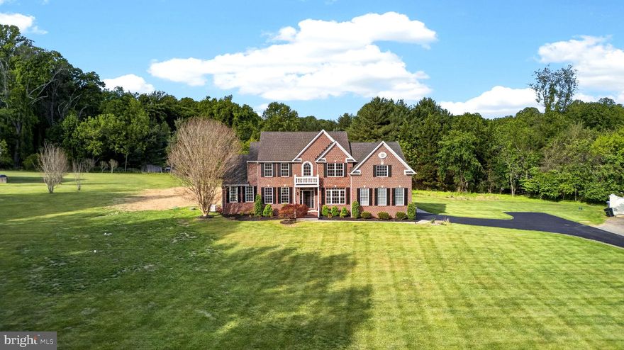 Welcome to 8 Noah Court, set on two private acres and offering over 6,200 square feet of beautifully designed living space. This impressive Colonial combines timeless style with modern comfort, complete with the convenience of an in-home elevator. The main level features a formal living room, elegant dining room, private study/office, and a main-level bedroom, ideal for guests or flexible living. The spacious kitchen is equipped with 42" cabinetry, stainless steel appliances, and a bright breakfast area that opens to the inviting family room, creating a seamless flow for everyday living and entertaining. Just off the kitchen, step outside to a custom paver patio with LED lighting, overlooking a peaceful and private backyard. Upstairs, you’ll find four generously sized bedrooms and three full bathrooms. The primary suite offers a relaxing sitting area and a large en-suite bath. A secondary bedroom features its own private full bath, while the remaining two bedrooms share a beautifully renovated hall bath. The finished lower level provides even more space to unwind and entertain, with a large family/rec room, dedicated media room, and convenient walk-up access to the rear yard. Ideally located for commuters, this home offers easy access to major routes including MD-26, Route 99, I-70, and I-695. Schedule your tour today!