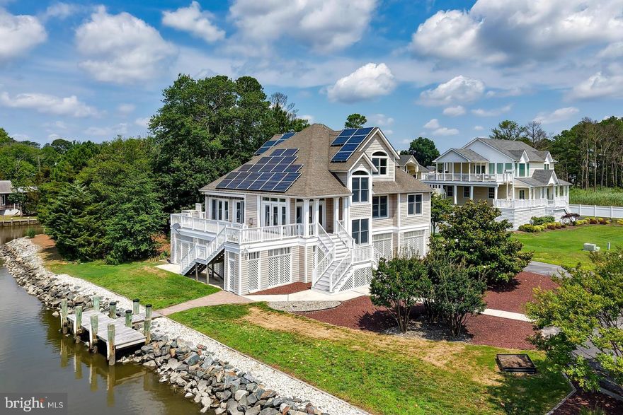 WATERFRONT STUNNER - A Coastal Retreat! Unlock the lifestyle you've always dreamed of with this exceptional waterfront home, perfectly situated on a rare half-acre lot surrounded by water on two sides. Enjoy breathtaking 180-degree panoramic views of the Rehoboth Bay, the Lewes Rehoboth Canal, the Dewey Beach Skyline, and serene Thompsons Island - all from your own backyard.  Take in the sights and sounds of the surrounding natural beauty & wildlife as well as seamless access from the private dock to the Lewes Rehoboth Canal and The Rehoboth Bay.  Whether you are sipping coffee while watching the sunrise or entertaining on an expansive deck (inclusive of a chair lift), this home offers a front-row seat to waterfront living at its finest. With three levels of spacious living, this home is more than just its unbeatable waterfront location. Ground level amenities include garage parking, abundant storage, a solar panel battery room, powder room, and a patio area perfect for entertaining. The main level’s dramatic great room features a fireplace & vaulted ceiling, with expansive windows and doors leading to a wrap-around deck - all open to the dining room &  kitchen.  The open-concept kitchen features white cabinetry, granite counters, walk-in pantry and stainless appliances. Enjoy 4 spacious bedrooms: two on the upper level with walk-in closets & en-suite “Jack & Jill” bath, and two on the main level, including the primary suite with private bath & walk-in closet with custom storage system.  Energy-efficient solar panels help keep utility costs low and even offer potential for additional income through energy resale. 
Situated with easy access to the vibrant Rehoboth and Dewey Beaches, and a plethora of restaurants and attractions, this location is unparalleled.  This is more than a home - it's a lifestyle! So start living the boating and beach life you've always desired. Don’t miss out on this rare waterfront opportunity — your perfect coastal retreat awaits!