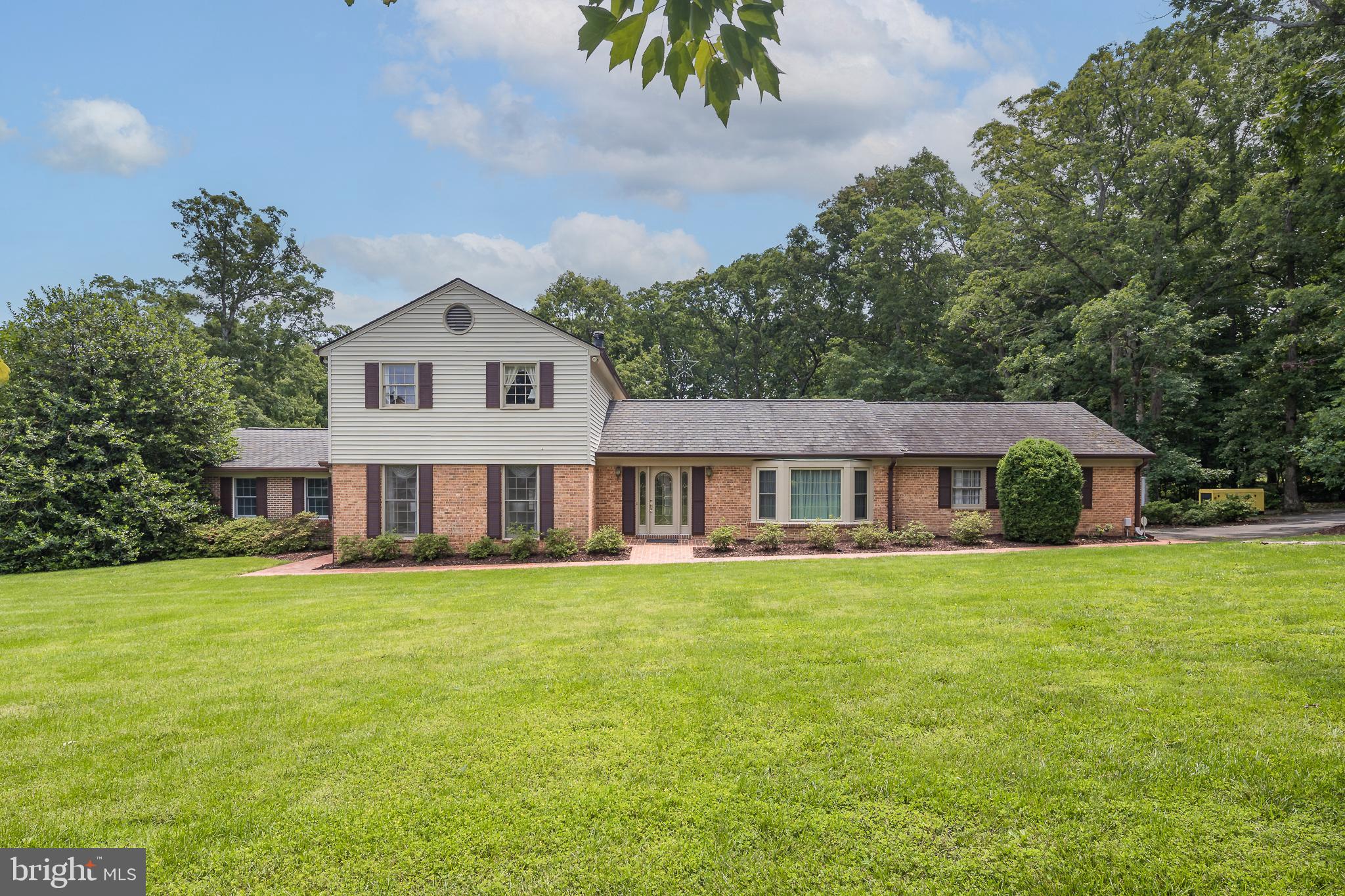 *** $45 K Price Reduction! *** Welcome to your perfect piece of paradise - on a beautifully treed 1.8 ACRE LOT! This beautiful 5 BR*/3.5 BA 4,000 sq ft home is just minutes away from abundant shopping and dining options, as well as quick commuting access to the VRE, Prince William Pkwy, I-95 and Rt 1. ****Step INSIDE the foyer and walk into the expansive Family Room with a vaulted ceiling and brick fireplace. The MAIN LEVEL also has a light and bright eat-in kitchen with back door access to the 2-car garage, a dining room and a spacious living room. A separate main level addition was added with a huge Primary bedroom that boasts hardwood floors, a walk-in closet and en-suite bathroom. It also includes its own separate laundry area! The UPSTAIRS was completely remodeled in 2019! There is a second primary bedroom with hardwood floors and a gorgeous en-suite bathroom with double vanities and walk-in shower, The upstairs also has 3 more spacious bedrooms and a beautifully remodeled hall bath. The lower level has a finished rec room, unfinished laundry & storage area and walk upstairs to the backyard. ****Step OUTSIDE the family room sliding doors to the large concrete patio that is perfect for relaxing, grilling, entertaining and overlooks an expansive backyard! Need extra storage space or want to store a vintage car? Then the 30x30 shed/workshop that is built on a concrete slab is the perfect place for it! There is paved access to the workshop which includes electricity and lighting. Home is also equipped with a Generac whole house generator! ****Don’t miss out on this delightful home! Schedule a viewing today and start imagining all the wonderful memories you’ll create here!