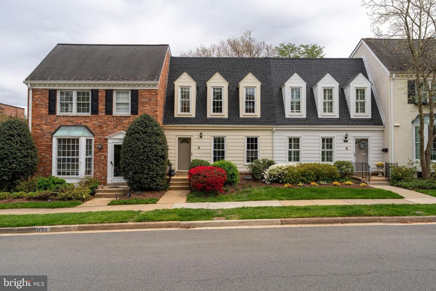 Updates galore! This townhome in sought after Kings Manor is a stunner! Prepare to be wowed by the beautiful kitchen remodeled in 2023 with high quality soft close custom cabinetry, instant hot water & filtered water on tap, a Wolf induction range & microwave, Thermador fridge, range vent & under counter wine fridge. As you enter there is a separate dining room on your right with gorgeous custom drapery and designer chandelier. On the left is a tastefully renovated powder room. Walk down the hallway to the spacious family room area with a wall of beautiful custom built-in bookcases that anchor the room and allow for plenty of storage and showcasing. Flanking the fireplace you will also find custom built-ins. Head up stairs to 3 bedrooms, all with hardwood flooring and ample closets. The upper level bathrooms feature updated vanities and mirrors. The lower level has been completely updated and boasts new LVP flooring, a 4th bedroom, new stair railings and hardwoods on stairs, renovated basement bathroom, new basement sliding door to rear flagstone patio and added built-in. Relax and entertain at the rear oasis that has been thoughtfully landscaped by Land Art. Use the rear gate to access additional parking on the street behind the home. 
Enjoy energy efficient heating and cooling with a new heat pump (2022), and new backup electric furnace (2023); new electric water heater with it's own heat pump (2022); and new attic insulation!  You will also enjoy the benefit of a whole house water filter and newer roof (2021). Easy commuter access to Rt.123, GW Parkway, 66, 495, and the Silver Line Metro. There is plenty of on-street parking available, sidewalks throughout and community grounds for you to enjoy. This impeccably maintained and updated home is a true gem in a fabulous location!