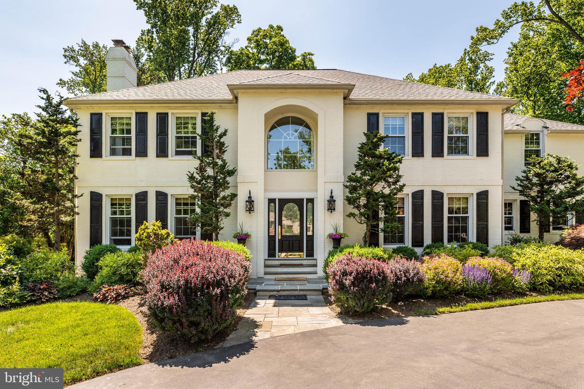 Located on one of the most beautiful streets in Devon, this stately home combines all the elegance and charm of the Mainline. The circular driveway and lush landscaping are the perfect backdrop to the dramatic entrance with flagstone steps. You almost feel as though you are entering a European villa as you stand outside the front door. It is easy to picture your guests entering the grand foyer with its sweeping staircase. Notice the detailed millwork throughout the home and two coat closets. To your right is the formal dining room, large enough to accommodate seating for twelve. To your left, step down into the formal living room with a gas fireplace and pristine oak flooring. What a beautiful room! Straight ahead leads to the heart of the home, a magnificent kitchen and family room. This versatile gathering space is ideal for entertaining. Whether you are hosting a party or just a tv night at home with the family, this is the room all will gravitate towards. This spectacular room includes a tray ceiling, multiple built-ins throughout, surround sound, window seat with drawers and a floor to ceiling double-sided stone wood-burning fireplace. A wall of windows overlooks the backyard and sliders lead to the patio. Two different areas of the room can be used for casual dining. The current owners love dining in front of the fireplace in the winter. Step up into the chef’s kitchen with custom cabinetry, granite countertops, Thermador appliances, Sub Zero refrigerator and wine fridge, two Bosch dishwashers, a coffee bar, wine bar, large pantry and informal counter seating. Located off the kitchen is a powder room, a laundry area with a built-in desk, a “doggy bath” for the resident pooch, access to the patio and backyard and a back staircase. A mudroom features five lockers and a window seat with storage and easy access to the three-car garage and driveway. There is a place for everything in this organized household! Another powder room and very private office with a gas fireplace and bright windows are off the family room. Not to be missed is the covered flagstone patio overlooking the stunning park-like setting of the expansive fenced backyard with mature trees and flower beds. There is also a storage shed for gardening tools and machinery. Sitting on this patio with a glass of wine in hand and something on the grill, is the ultimate relaxing summer evening! Upstairs is the primary suite, resplendent with a built-in bookcase, fireplace and luxurious ensuite bathroom with heated tile flooring, double vanity and steam shower. You will not be able to live without the “his and hers” walk-in closets with built-ins and the dressing/makeup vanity with drawers. Truly a luxurious retreat! Down the hall, there are four other well-appointed bedrooms with large closets, each room delightful in its own way. All rooms have ceiling fans. Two rooms share a double vanity bathroom with a glass-enclosed shower. A bonus room between these rooms is ideal for a study area, yoga space or just extra storage. A hall bath with a double vanity, tub and heated tile flooring completes the floor. The finished basement is large enough for a workout/play/gaming area. A large cedar closet is ideal for winter clothing storage and there is a full bath with a shower. All utilities are housed in the basement with plenty of additional storage space. A whole house generator is included. The home is located near major commuter routes, train stations, golf courses, shopping and restaurants. Even though you will be in the award-winning Easttown School District, there are also many outstanding private schools in the area. Do not miss this very special opportunity to own one of the Mainline’s finest!