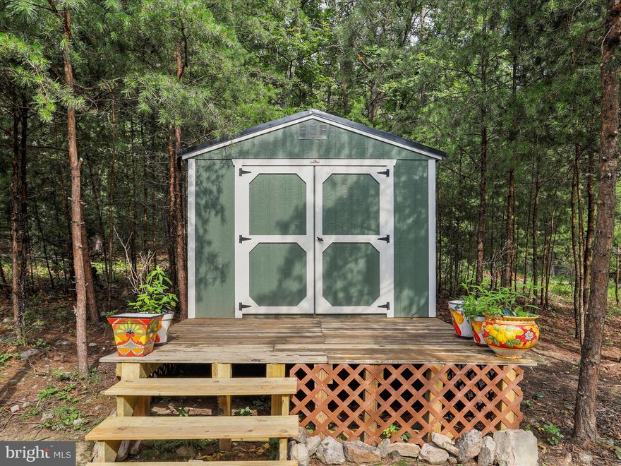 Come to wild and wonderful West Virginia to discover this slice of heaven. This property has a converted building with a front deck to be used for camping and an additional storage shed to keep personal items. Enjoy the usable acreage on top of Island Ridge to hike and enjoy the ponds on the property. Currently used for camping, this land would be ideal as a build site. The fruit bushes and mature trees make for a serene setting. The gated community offers nearly 20 riverfront acres of private land for  property owners to enjoy. The opportunity is here for you to purchase a mountaintop parcel with sought after usable acreage and ponds! Who is ready to spend quality time camping or dreaming to build their perfect mountain getaway?!