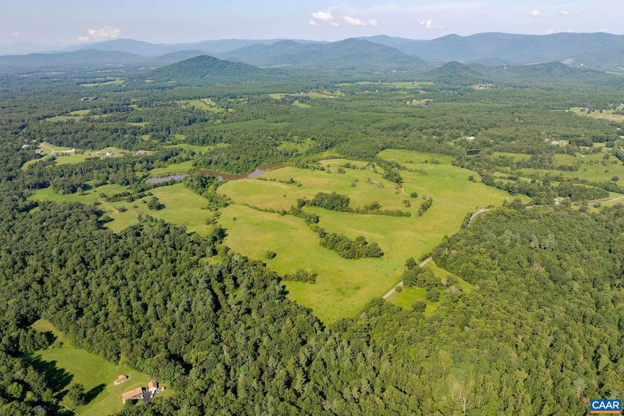 Named for its geographic relation to a nearby sister farm, The Upper Farm spans 595 acres in Albemarle County with sought-after Blue Ridge Mountain views. The property features a 20-acre lake, over half a mile of road frontage, and a blend of rolling pastures and mature woodlands, offering numerous homesite options. Located just 14 minutes from the Charlottesville Albemarle Airport and a little over 25 minutes to UVA, this property uniquely combines scenic seclusion with convenient access. With 12 distinct parcels and an existing farmhouse that can be utilized or reimagined, The Upper Farm is primed for diverse opportunities?from agricultural ventures to creating an exceptional recreational retreat. Additional acreage across Simmons Gap Road is also available for expanded possibilities.