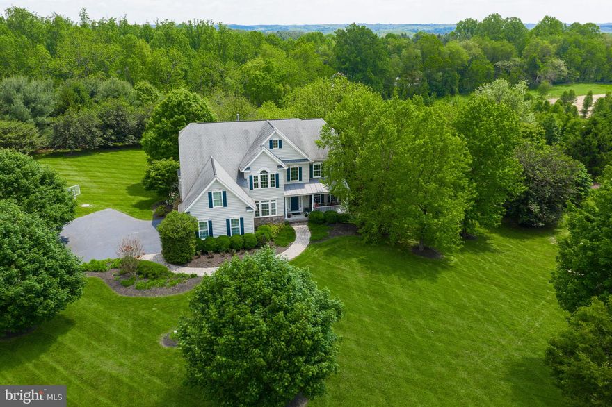 ****Stunning Colonial on 3.64 Acres! Premium Lot!!! Gleaming Hardwood Floors, Lofty Windows, Light Filled Interiors, Soaring Ceilings, Strong Moldings, and Stunning Design-Inspired Features and Detail Throughout! Spacious Living and Dining Rooms Embellished with Crown Molding, and French Doors. Eat-in Kitchen with Sleek black Appliances, Granite Counters, a Breakfast Bar, a Center Island, a Walk-In Pantry with Shelving, and Decorative Backsplash. Family Room set off the Eat-In Kitchen and Highlighted with a Fireplace. Master Suite with Huge Walk-In Closet, a Full Bath with Double Vanities, a Glass Enclosed Shower, and a Soaking Tub. The Lower Level Includes a Recreation Room, Exercise room and  Bedroom, a Full Bath, a Ballet/yoga studio, Storage, Upgraded Lighting, and Easy Access to the Backyard. Exterior Features Include Landscaped Grounds, Covered Front Porch, Backs to Trees, privacy is plentiful. Custom basement finished by builder 9' Ceilings throughout, including basement 2 staircases to upper level Hardwood floors throughout main level Tons of storage (esp. garage) A MUST SEE!