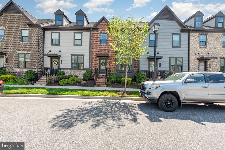 Absolutely stunning, 4 bed, 2.5 bath modern townhome with 2 car garage, and fully finished basement.  You don't want to miss this one!  This neighborhood has a huge, beautiful community center, outdoor pool, dog park, walking trails and fitness center.  Just off of 43 with quick access to I-95, Rt 40 and Eastern Blvd and located within seconds of restaurants, shopping and gyms.  Park out front on the street or pull into the large rear entry 2 car garage.  Just built in 2018 this home is new, updated and well maintained and in an ideal location.    The main level is completely covered in high quality engineered hard wood flooring with a full open concept.  The living room, with updated stone accent wall and built in electric fireplace, flows seamlessly into the modern kitchen and dining area.  The kitchen has a large granite island, and granite countertops, backsplash and full stainless appliances, as well as a large pantry to go along with all of the custom cabinetry.  The dining area has gorgeous wainscoting lining the walls and French doors that lead out into the rear courtyard.  There is just enough grass out back to allow pets room for duties, as well as privacy fencing and a paver patio for enjoying the weather and relaxing, grilling etc.  A door from the courtyard leads into the rear garage.  Back inside, stairs to the top floor lead to a full modern bath with tub/shower combo, a convenient top floor laundry closet with washer/dryer and three bedrooms.  Two of these upstairs bedrooms have walk in closets, including the large primary suite with tray ceilings and its own private full modern bath with a soaking tub and walk in tiled shower.  Taking the stairs to the basement leads to a large finished living/recreation area with beautiful built in accent wall with cabinetry and an electric fireplace, as well as a convenient powder room and storage/mechanical room.  French doors on this level lead to another room that currently serves as a fitness room but could easily be converted to a bedroom.  All functions and mechanics of this house are modern and well kept, the tankless hot water heater allows for limitless hot water.  This home is updated, and move in ready and waiting for you to come call it home.