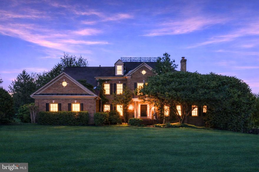 Exceptional Great Falls estate offers 7600 square feet of timeless brick colonial architecture on just over two private acres, a combination that is increasingly rare in today’s low-inventory luxury market. The setting is serene and beautiful, highlighted by a stunning rectangular heated pool and spa with a flagstone patio and pool deck that creates a true resort-style experience at home. The home opens to a generous foyer, where a sweeping hardwood staircase creates a sense of arrival and timeless  presence. It features light, like-new hardwood floors throughout the main and upper levels, brand new paint across the entire home, and a floor plan that is both gracious and highly functional. Nine-foot, vaulted and cathedral ceilings enhance the sense of style and space, while natural light fills every room. The kitchen serves as the heart of the home, with gas cooking, granite countertops, a Bosch dishwasher, a three-door refrigerator, a walk-in pantry, and seamless flow to the morning room, two-story family room with a raised brick hearth fireplace, and an expansive deck. Kitchen island and table space. These areas provide multiple vantage points overlooking the private fenced backyard, spa and pool. The conveniently accessed three-car garage and laundry room, just off the kitchen, add ease to daily routines. Exterior side door from laundry room. New asphalt driveway. The main level includes a private office, formal living and dining rooms, sunroom. Upstairs are four generously sized bedrooms with crisp white bathrooms, each thoughtfully connected for comfort and privacy. Closet systems throughout the home reflect careful attention to organization. The primary suite is expansive and serene, with sitting room,  dressing room, walk in closet with  closet systems and bathroom with soaking tub, step in shower offer a spa-like atmosphere. The walkout lower level extends the living space beautifully. It features an expansive fitness studio with an infrared sauna, equipment and bamboo flooring. The fifth bedroom and full bath are above ground and light-filled. Located just off the lower-level recreation room and gas fireplace, they provide ideal accommodations for guests, extended family, or an au pair. Large double utility room/storage rooms with built in shelving. This home delivers classic Great Falls elegance, modern livability in one of the area’s most sought-after locations. It is refined without being pretentious and expansive without feeling overwhelming.