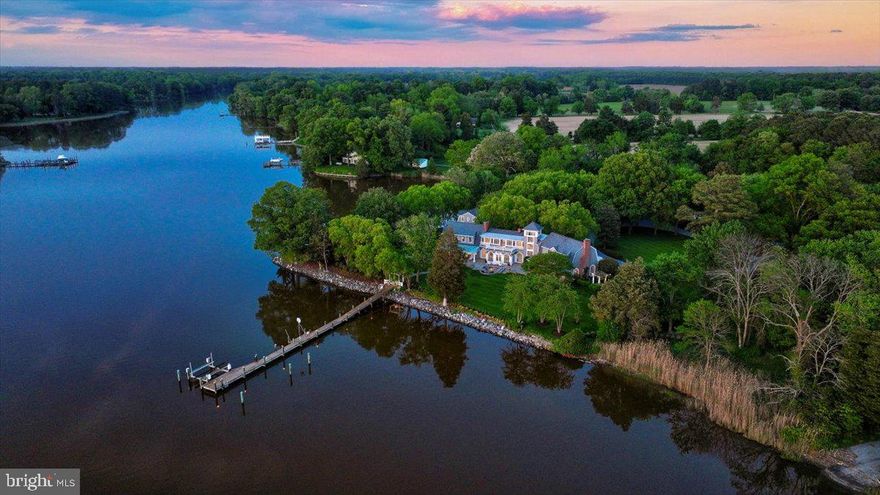 Stunning Waterfront Estate on the Miles River. This property has been immaculately maintained.  The original home was built in 1927 but was completely renovated in 1999 and has since gone through many updates.  The 3-bedroom, 3 full bath, 2 half bath, main house has beautiful hardwood floors throughout, crown moldings, exposed beams, and wood-burning fireplaces.  The most discerning chef will find everything they need in the gourmet kitchen including a huge island that seats 7, a Wolf 4-burner gas cooktop with French burner, a Wolf double wall oven, a Miele French door refrigerator/freezer, two dishwashers, 2 farm sinks, and a prep sink.  Enjoy meals in your casual dining area with wood-burning fireplace or formal dining room, both with easy access to wet bars, great for entertaining.  A sunk-in seating area with brick floors provides French door access to a patio with a spa.  The formal living room includes a wood-burning fireplace with sliders to a covered brick patio.  The main house is equipped with geothermal HVAC and a whole-house reverse osmosis system, an unfinished basement, and a new roof was installed in 2023.

Upstairs you will find a loft that provides the perfect spot for an office nook, a laundry room, 3 ensuite bedrooms, and a den.  The primary suite includes a wood-burning fireplace, sitting area with built-ins, and sliders to a private balcony.  The primary bath includes 2 walk-in closets, one with a vanity, 2 showers, 2 water closets, a double sink, and a soaking jet tub.  The second guest bedroom is large enough to be another primary suite and includes built-ins, a wood-burning fireplace, a walk-in closet, a slider to a roof-top deck, and a private bath.  The third guest bedroom is off a large den and has built-ins, a walk-in closet, private bathroom, and a ladder to   a loft area.  This second level can be accessed from two separate staircases.  Another set of stairs leads to a third-level observation tower.

Outside you will find extensive landscaping and hardscaping including beautiful slate walkways and mature trees with uplighting.  The property boasts a dock equipped with a boat lift, as well as access to water and electricity, and a riprapped shoreline.

A small cottage on the edge of the point provides stunning views, a living room with a gas fireplace, a mini kitchen, and a full bath. The one-car detached garage has a large bonus room above and tons of storage.  There is also a 2-bay detached machine garage with storage on the property.  The barn, which was converted to a caretaker’s cottage in 2007, has an inverted layout that has 2 ensuite bedrooms on the main level, and a living room with a slider to a balcony, kitchen, and powder room on the second level.  The guest house, brand new in 2022, features a large living room, dining area, kitchen, office, laundry room, and 2 ensuite bedrooms.  An in-ground pool and a gazebo with a wood-burning fireplace provide the perfect spots to entertain guests.  This property has it all!

Easton, Maryland, known as the New Hamptons of the Chesapeake Bay by Forbes Magazine, is conveniently located 1.5 hours from D.C. and Baltimore, and 2 hours from Philadelphia.  Just minutes from fine dining, shopping, healthcare, theatres, galleries, museums, golf courses, a country club, a yacht club, and a jet airport.