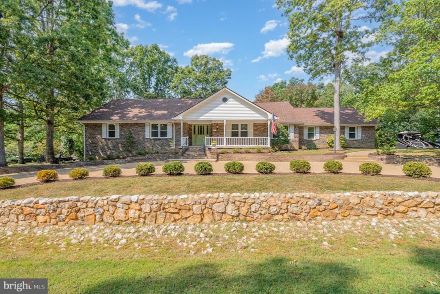 SELLER STILL ALLOWING SHOWINGS AND ACCEPTING BACKUP OFFERS . Gorgeous  & Rare Single-Level Brick Home in Sought-After Woodlawn. Tucked away on a picture-perfect cul-de-sac, this beautiful home truly feels like a fairy tale setting. A circular front driveway with a landscaped stone wall and  beautifully landscaped island welcomes you, while a secondary driveway leads to a 2-car garage—providing plenty of parking for family and guests.
Step inside to discover a stunning kitchen featuring all-white cabinetry, marble quartz countertops, walk-in pantry, stainless steel appliances (including slide-in range), and a built-in wine fridge. A large island with barstool seating overlooks the spacious, light-filled family room with fireplace. The home also offers a formal dining room and living room with elegant crown molding. Throughout both levels, you’ll find luxury 9” wide plank flooring that enhances the home’s high-end appeal. The finished daylight basement (approx. 1,100 sq. ft.) adds exceptional living space with a large rec/family room, an additional bedroom with closet, and a full bath. There’s also a finished workshop area—perfect for hobbies, projects, or extra storage.
Recent updates within the last 5 years include: new roof, HVAC, windows, fence & firepit, and screened porch—making this home move-in ready.
Enjoy the perfect location: walking distance to shopping and amenities, just 5 minutes to Downtown Fredericksburg, I-95, and the Leland Station VRE. Optional membership is also available at the nearby Grafton community pool.
This home combines rare single-level living, modern upgrades, and timeless charm—you truly have to see it to appreciate!