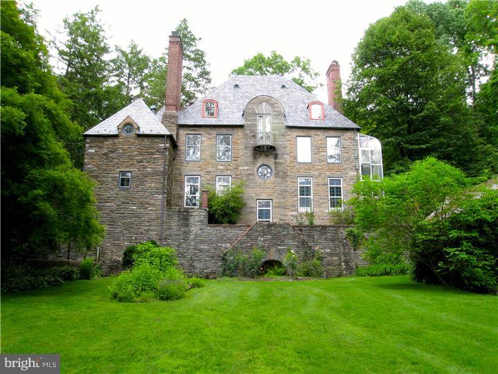 Sophistication and comfort. Remarkably beautiful 1919 stone manor house on 2.5 acres abutting park and the Wissahickon Creek. Designed by world-renowned architect and Chestnut Hill resident George Howe with the romanticism and French-Italian spirit of Howe's High Hollow above it on Hampton Road but with more defined architectural idea of "human necessity" so the floor plan is marvelously functional--even in today's world. The whole house is on a human scale. No energy wasting cathedral ceilings here! Most rooms face the southern sun. Big functional cook's kitchen with marble island/5 burner gas cooktop/electric wall ovens/Sub-Zero refrig-freezer/abundant counter and storage cabinets/kitchen garden, 1st floor powder room, stunning LR and DR with wood-burning fireplaces, quiet book-shelf-lined library, master BR suite with to-die-for master bath and great closets, 2-story green house added by previous owner. Yellin iron work. Lower level family rm/gym w/sauna. Outbuildings conveyed as-is including stables with attached garage, carriage house with 2-car garage and studio apt above, rustic stone spring house. Stone-paved courtyard. Sweet private patio. Fertile gardens and sweeping lawns that go all the way to the park. Property fenced for privacy. Many upgrades throughout. Direct entry into the park makes this property paradise for naturalist/gardener/fisherman/hiker.
