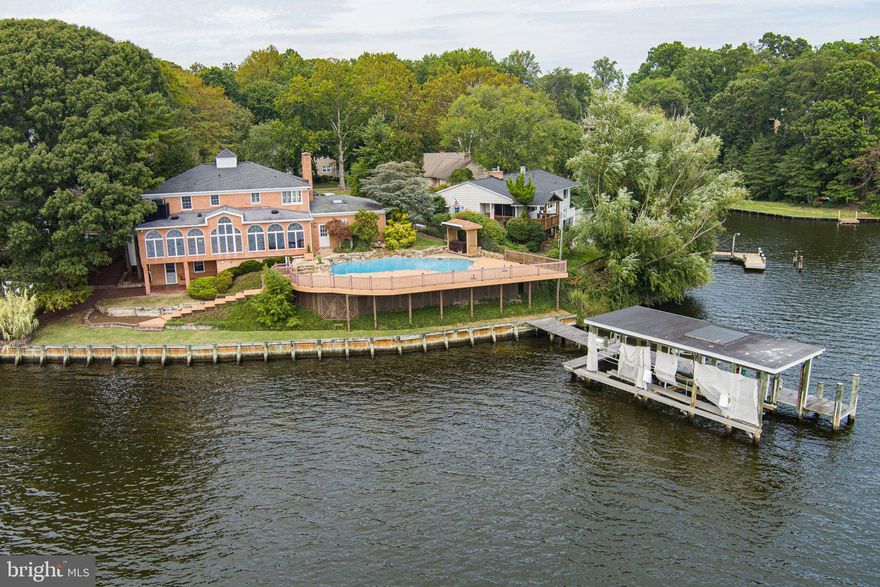 Welcome to 508 Ashberry Lane, a rare offering in the highly coveted West Severna Park community. Over 150 ft of waterfront nestled along Yantz Creek, just off the Severn River, this stately brick colonial blends timeless architecture with the luxury of true waterfront living. Step inside and you’re immediately drawn to the sunroom, where a wall of soaring arched windows provides breathtaking views of the water and floods the interior with natural light. Just off the sunroom is the custom kitchen which includes a Sub-Zero refrigerator, Wolf stove, premium cabinetry, granite counters, two islands, wet bar, wine refrigerator and more. Hardwood floors and a warm, inviting layout throughout the main level create a sense of comfort and sophistication. Outdoors, the property transforms into a private resort. The heated in-ground pool sits just above the shoreline, surrounded by stonework and expansive decks that invite you to entertain or simply unwind. From the pool deck, take in panoramic vistas of Yantz Creek and the Severn River as boats pass by — a scene that captures the very essence of the Chesapeake Bay lifestyle. A private 75 ft pier with two boat lifts (10 ton and 1.25 ton) puts the Severn River at your doorstep, offering endless opportunities for boating, fishing, and water sports. This home is designed for both luxury and peace of mind. A full backup automatic generator ensures uninterrupted comfort, while the highly sought-after West Severna Park neighborhood provides exclusive access to a private community beach, picnic area, playground, basketball court and marina. Add in the top-rated Severna Park schools and an ideal location close to Annapolis, Baltimore, and Washington, and you’ll find the perfect balance of tranquility and convenience. 508 Ashberry Lane is more than a home — it’s a destination. Rarely does a property combine timeless elegance, resort-style amenities, and one of Severna Park’s most desirable waterfront settings. This is your chance to make the Chesapeake lifestyle your own