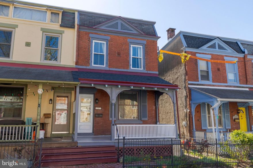 Step Into History with Modern Comforts.   Built before 1895, this charming semi-detached home is a beautiful blend of timeless character and thoughtful updates, ready to welcome its next chapter—and yours. From the moment you arrive, the home enchants with its newly refreshed, gingerbread-trimmed front porch, original hairpin iron fence, classic brick walkways, and an original front door that tells stories of a bygone era.   Inside, the craftsmanship of the 19th century is immediately evident in the refinished, random-width heart of pine floors that run throughout. The living room showcases a stunning original mantle flanked by built-in bookshelves, and a striking 3-over-3 light front window with handmade glass, flooding the space with warm, natural light.   The layout feels surprisingly modern, with an open floor plan that enhances flow and connectivity. A thoughtfully designed breakfast bar peninsula opens the kitchen further into the living space, allowing light to stream in from a beautiful stained glass window. The kitchen is a chef’s delight, featuring a slate floor, granite countertops, and newer stainless steel appliances—including a dishwasher and built-in microwave.   Upstairs, you'll find three spacious bedrooms and an updated hall bathroom. The main bedroom is especially generous, with two large windows and a well-optimized closet for storage.   Out back, a large deck and yard with flowering shrubs provide the perfect setting for outdoor entertaining or quiet moments of relaxation. Recent updates include energy-efficient double-pane sash windows, a recoated roof, a new hot water heater (2021), freshly painted exterior trim, and new porch steps.   Don’t miss your chance to own a piece of history with all the comforts of today.