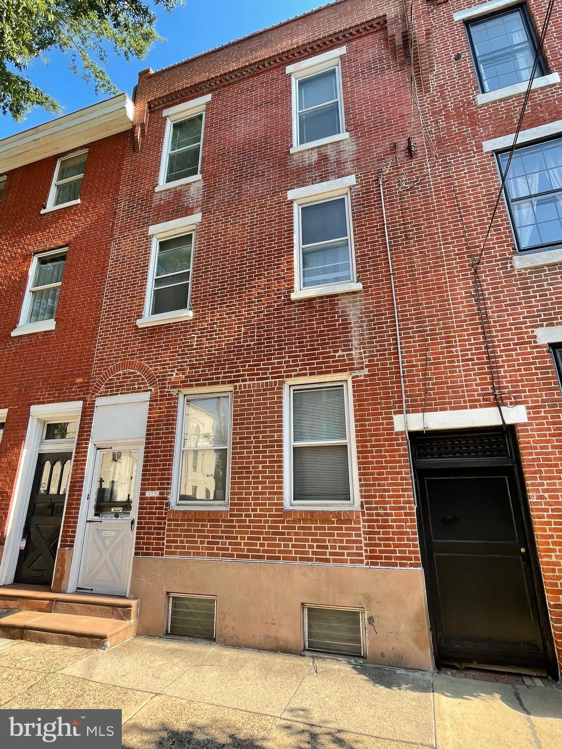 Are you dreaming of owning a piece of history in one of Philadelphia’s most sought-after neighborhoods? This is your chance to make that dream a reality with a rare opportunity to own one of the last Grandmom homes in Queen Village located on one of the finest tree-lined blocks. This one is special and just waiting for you to transform it into your dream home.
Located at 223 Fitzwater St., this mini-mansion spans 20 feet in width and 90 feet in depth. It features seven bedrooms and 2.5 bathrooms, falling within the Meredith School catchment. The home offers abundant space, soaring ceilings, and original hardwood floors. With charming woodwork and beautiful original fireplaces, the home exudes character and warmth. Large windows at the front, rear, and side fill the home with natural light, enhancing its welcoming atmosphere.
The grand foyer welcomes you into a world of possibilities. There are two spacious living rooms, each graced with Pennsylvania blue marble fireplaces. The dining room is expansive and bright with a powder room and side windows, perfect for hosting gatherings. A huge eat-in kitchen provides access to an expansive yard and large side breezeway.
The second floor boasts four sizeable bedrooms, each with high ceilings. Some rooms offer windows on multiple sides, ensuring ample light. A full tile bath adds to the convenience and comfort of this level.
Originally designed as an in-law suite, the third floor features three spacious and versatile bedrooms, a full bath to ensure privacy and comfort for guests or family members, and a large, functional eat-in kitchen perfect for extended family living. A rear door provides access to potential outdoor living space.
The property includes a huge, unfinished basement that runs the entire footprint of the home, offering flexible space for storage or future development.
This property is being sold in “as-is” condition, but the potential is immense. Don’t let this become your “could have, should have” home. Schedule your appointment today, bring your imagination, and explore the vast possibilities that await at 223 Fitzwater St. With its generous space and unique charm, this Grandmom home in Queen Village promises not to disappoint. Seize this rare opportunity to create a dream home that reflects your vision and style.