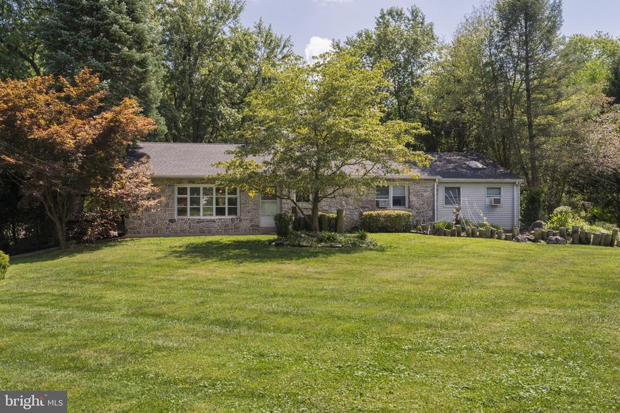 Are you looking for a ranch home?   Well look no further.    This 4 bedroom, 2 bath  home is your answer. You'll enter the front door onto original hardwood flooring and cannot miss the unique curved floor to ceiling stone, wood burning fireplace!  The large eat in kitchen is functional, has a breakfast bar and can accomodate the largest of dining tables.   As you travel down the hall, you'll find the sleeping quarters.    The first bedroom is used as an office, the 2nd bedroom was the original main bedroom and the 3rd bedroom has a built in bookshelf and is currently used as an exercise room.  At the end of the hall is the addition of the owner's suite, complete with a sitting area, walk in closet and it's own bath and a large bay window that overlooks the backyard.   The other 3 bedrooms are serviced by large hall bath.   There are pull down stairs in the hallway to get to the floored attic for storage.   The basement is HUUUUUGGE  and  where the family room is located.  Complete with swinging western doors,  a bar and pool table.    The unfinished part of the basement holds the mechanicals of the home and an area fore even more storage (lawn furniture,  holiday decorations, bring it on!)     Bilco doors lead to the back yard.     The home sits on  level lot and can satisfy anyone and everyone's needs.  Want to barbeque and dine alfresco?  Please do so on the covered  patio located off the side exit of the kitchen.   Enjoy your favorite beverage on the deck where you access from the french doors of the kitchen.    Or gather around the fire pit and watch the fireflies. The home has been meticulously maintained, however you may want to complete your own updates, like exposing the hardwood floor under the carpets in the bedrooms.  Whatever your desire, you can make it yours in this home!