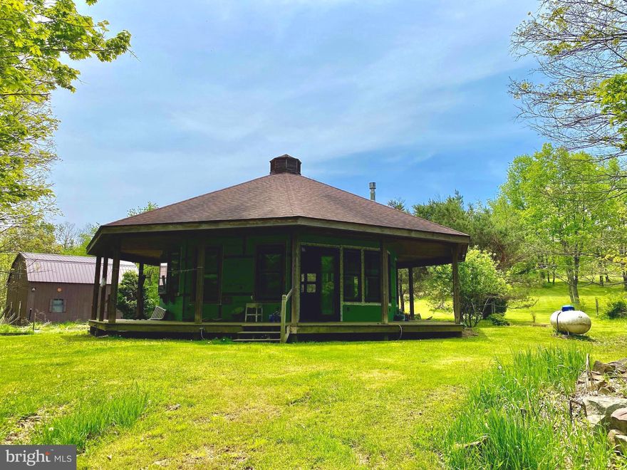 VERY PRIVATE AND SECLUDED 10 ACRE ESTATE WITH UNIQUE OCTAGON HOUSE.  WRAP-AROUND COVERED PORCH, SHINGLE ROOF, DOUBLE HUNG WINDOWS, SLIDING GLASS DOOR, DETACHED 2-CAR BARN STYLE GARAGE WITH 2ND FLOOR LOFT. RUSTIC INTERIOR OFFERS OPEN FLOOR PLAN WHICH INCLUDES GREAT ROOM AND DINING AREA W/DRYWALL & PINE WALLS, HARDWOOD FLOORS, WOODSTOVE.  KITCHEN OFFERS ALL APPLIANCES, INCLUDING WASHER & DRYER, OAK CABINETS & HARDWOOD FLOORING.  LARGE BEDROOM W/T&G CATHEDRAL PINE CEILINGS, AMPLE CLOSET SPACE AND HARDWOOD FLOORS.  PROPANE HEAT, ELECTRIC BB HEAT. FULL BATHROOM WITH CERAMIC TILE WALLS AND FLOORS,  OAK VANITY W SINK AND SHOWER. OTHER FINE AMENITIES: (2) DETACHED SMALL GUEST/RENTAL CABINS, ABUNDANT FRUIT TREES (APPLE & PEAR), GRAVEL DRIVEWAY, DEEDED 40’ RIGHT OF WAY.  SALE “AS IS” – “WHERE IS”.