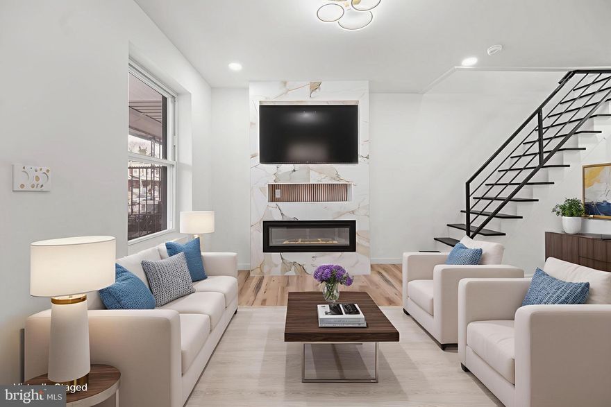 Welcome to 1513 N 57th St, a beautifully renovated 3 bedroom, 1 1/2 bath home featuring clean lines, modern finishes, and a thoughtfully designed layout for everyday living. From the private front patio to the bright, open interior, this move-in-ready property showcases quality updates throughout.

The main level offers an open-concept layout with wide-plank flooring, recessed lighting, and a striking electric fireplace wrapped in beautiful marble, creating a sophisticated focal point. The kitchen is both stylish and functional, highlighted by quartz countertops and a marble island, two-tone cabinetry, subway tile backsplash, brand-new stainless steel appliances, and a large center island with seating, accented by modern pendant lighting and gold fixtures. The first-floor powder room features a sliding barn door and elegant finishes.

Upstairs, you’ll find three well-sized bedrooms with ample natural light and closet space, along with beautifully updated bathrooms showcasing marble tile and contemporary fixtures. Additional highlights include a full basement offering storage or flexible use, and a sizable backyard, ideal for entertaining, gardening, or relaxing outdoors.

With updated electrical and plumbing, modern stair railings, and cohesive high-end finishes throughout, this home is truly move-in ready. Schedule your private showing today.