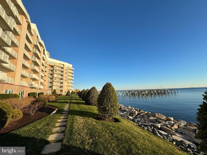 This condominium, nestled within a luxurious gated community, offers a panoramic view of the Chesapeake Bay. Step inside and be captivated by the elegant charm that Horizons on the Bay offers. This highly sought after corner condo with 2 bedrooms and 2 full baths, is designed to provide comfort and convenience for everyday living. The fully equipped kitchen boasts tile flooring, abundant counter space, and ample storage. Enjoy the wide-open living room with its direct waterfront view, cozy fireplace and LVP flooring. Unobstructed views can be enjoyed not only from the living area but also from the primary suite. This corner unit offers additional windows in the primary suite giving you a true panoramic bay view along with a generous walk-in closet. The primary bath offers a spacious vanity and walk-in shower, custom built-in storage and office nook. This unit also offers a second bedroom, separate laundry and second full bath. From your 3rd floor private balcony, enjoy unobstructed views of the breathtaking sunsets and abundant wildlife including osprey, heron and bald eagles. The balcony spans the entire length of the condo and can be accessed by both the living room and primary suite. Whether you're seeking relaxation or adventure, Horizons on the Bay offers a multitude of amenities and nearby attractions to suit your every need. Indulge in the heated rooftop pool, perfect for unwinding after a long day. Stay active and maintain your fitness routine at the well-equipped fitness center. Get lost in a good book at the library or gather with friends and family at the picnic area complete with grills and a firepit. Enjoy the day fishing or crabbing from the large community pier. Convenient to restaurants, shopping, beaches, boardwalks, the community water park, charter fishing, marinas, and is an easy commute to Annapolis, DC, Baltimore and several military bases.

Additional information:
The linen closet in the primary bathroom was turned into an office nook and the tub was converted into a storage closet. The tub is still fully functional. There is a second tub in the other bathroom.