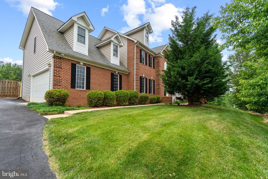 This spacious, one-owner home offers upgraded space for both family gatherings as well as entertaining. A grand, two-story entrance foyer with dual staircase provides a beautiful first impression. The gourmet kitchen has granite countertops, a center island and an abundance of built-ins added to the custom cabinetry. Work from home in the designated office space. Three bedroom suites allow the flexibility for multi-generational living if needed including a main level bedroom suite with oversized shower in the bathroom, gas fireplace and private deck. Upstairs contains the other two bedroom suites plus up to 2 additional large bedrooms that share the 4th full bathroom (the home currently percs for a 4 bedroom house) The primary suite includes a spacious walk-in closet, luxury master bathroom and a custom bar area that is great for enjoying both coffee and wine from the privacy of your suite. The third bedroom suite has a spacious sitting room, separate bedroom and private bath. The rear patio is an entertainers dream and includes a kitchenette with built-in 5 burner Blaze gas grill, frig and prep space plus decorative retaining walls that include electrical outlets set up for a hot tub. The main level and patio feature wired speakers through-out. A fire pit area and play area are also enjoyed in the fenced rear yard. The rear entrance has a ramp for wheelchair access (non ADA). The unfinished basement has roughed in plumbing and can be finished to add up to 1400 additional square feet of living space.  Located just minutes to I95, shops and access to Lake Mooney Park and the Rappahannock River.