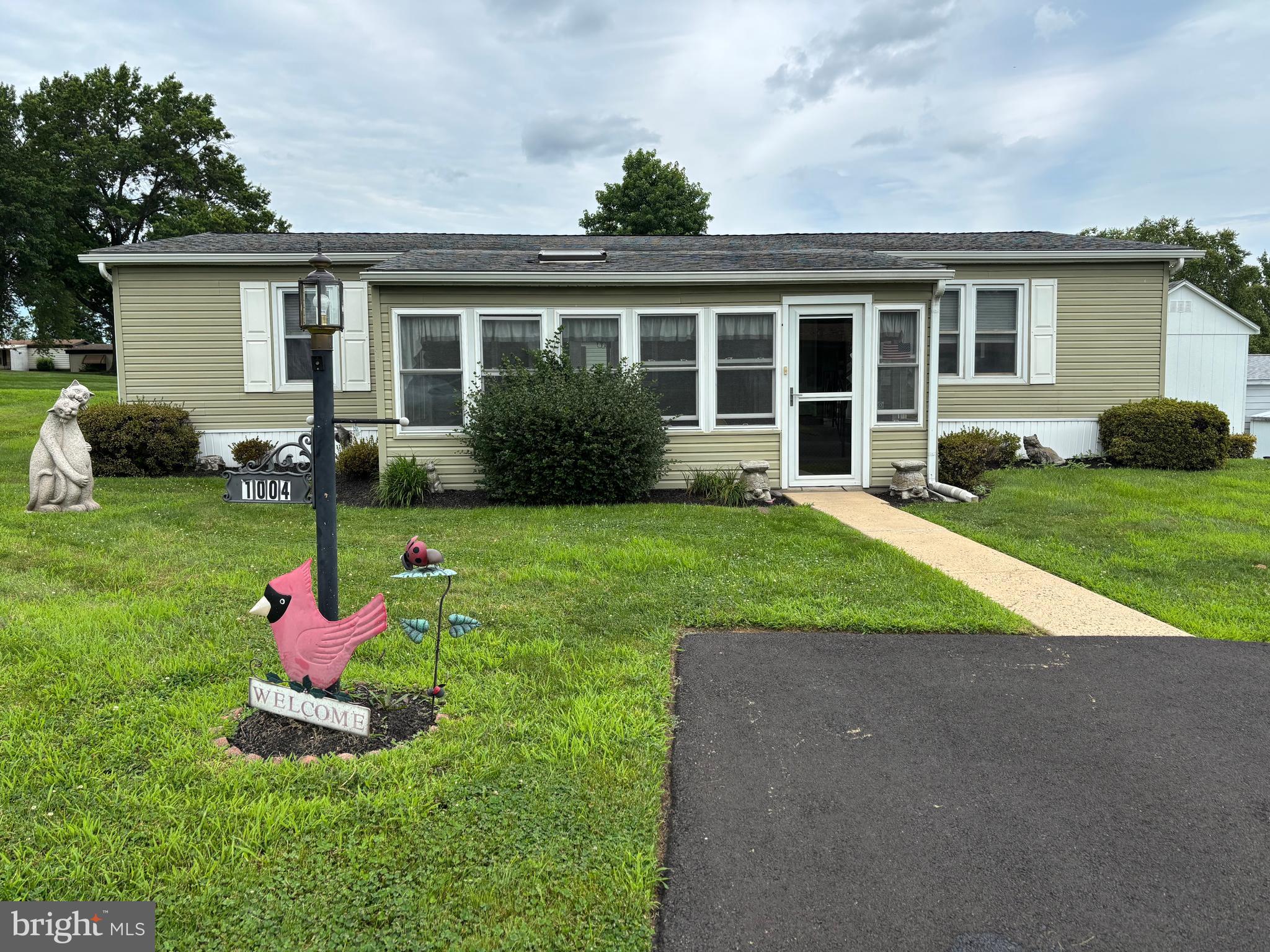 Welcome to this spacious 3-bedroom, 2-bathroom corner lot home with an enclosed porch, located in the 55+ Village of Neshaminy Falls. There is convenient parking right in front of your home, leading into a porch that features newer windows, a skylight, and a ceiling fan.
Step inside to the large living room, which boasts a bay window overlooking the porch. This area also includes a lighted ceiling fan and is open to the dining area. The dining room features a built-in china cabinet, a chandelier, and sliding glass doors that lead to an outdoor deck with an awning, perfect for entertaining.
The upgraded kitchen has newer cabinets, countertops, and appliances, along with a pendant light above the deep sink, recessed lighting, and an overhead fan. The kitchen also includes a breakfast bar, additional cabinets, and a food pantry for extra storage.
The laundry room is equipped with a washer, dryer, and stand-up freezer, alongside additional cabinetry for storage. From the kitchen, you will find the primary bedroom that includes an en suite bathroom with a shower stall. The guest bathroom has been updated to feature a walk-in tub, ideal for relaxing after a long day. Two additional bedrooms are just off the hallway and can also be used as either a den or an office. Make your appointment soon to see this wonderful home and add your finishing touches!