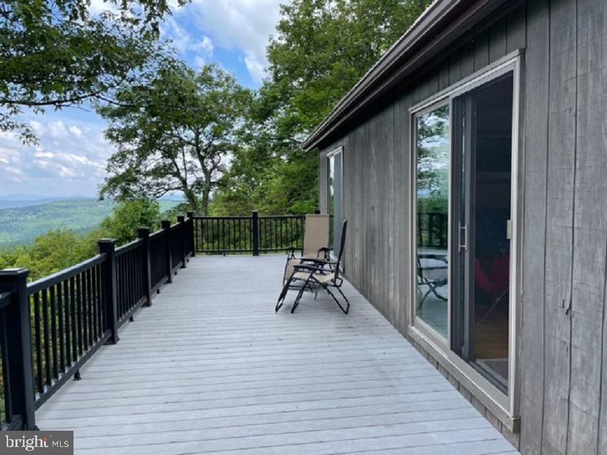 WORLD CLASS VIEW!  If you're looking for a great escape to off grid living, this is the place for you.  Come relax, breath in the clean mountain air and take in the spectacular views from the  deck of this beautiful and inviting 2 bed, 1 bath cabin.  Share your mountain top retreat with a couple more guests and make use of the spacious loft.  BRAND NEW Solar Panels recently added!  The generator is conveniently wired to be turned on/off from inside cabin. The propane stove keeps the temperature nice and cozy on those cool evenings and the LP Lamps are a wonderful convenience when the Generator isn't needed.  Maintenance free Trex decking means no time wasted on keeping those deck boards in tip top shape.   You'll also have access to a 9 acre Common Area, also with great views. 4x4 required in winter months.