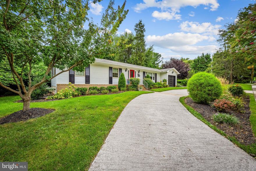 A charming home in “The Orchards” offers beautifully updated modern comfort and style in every corner. It features admirable landscaped grounds and the marvelously maintained, ranch-style home has a primary suite and 2nd bedroom with full bathroom on the entrance level. A guest suite on the lower level has a full bathroom, an office, plus huge open space with possibilities for a recreational room, children’s playroom,  home gym, etc.. This spacious two-level home boasts large living space, complete with updated gourmet kitchen, all stainless steel appliances, 3 full bathrooms, gleaming hardwood flooring, custom wood wall accents, elegant crown moldings throughout the house, updated lighting, and unique details that bring warmth and characters into modernized design with quaint elements added for elegance. The oversized attached garage is paired with a circular driveway that add several extra parking spaces and easy entrance and exit onto Lake Ave. Located conveniently quick-access to major routes, the house is walking distance to top public and private schools, shops, restaurants, and Lake Roland Park to relax. This is a charming home in The Orchards with a rarely available floor plan and design for ready accessibility. Please come and see the home; make it yours!