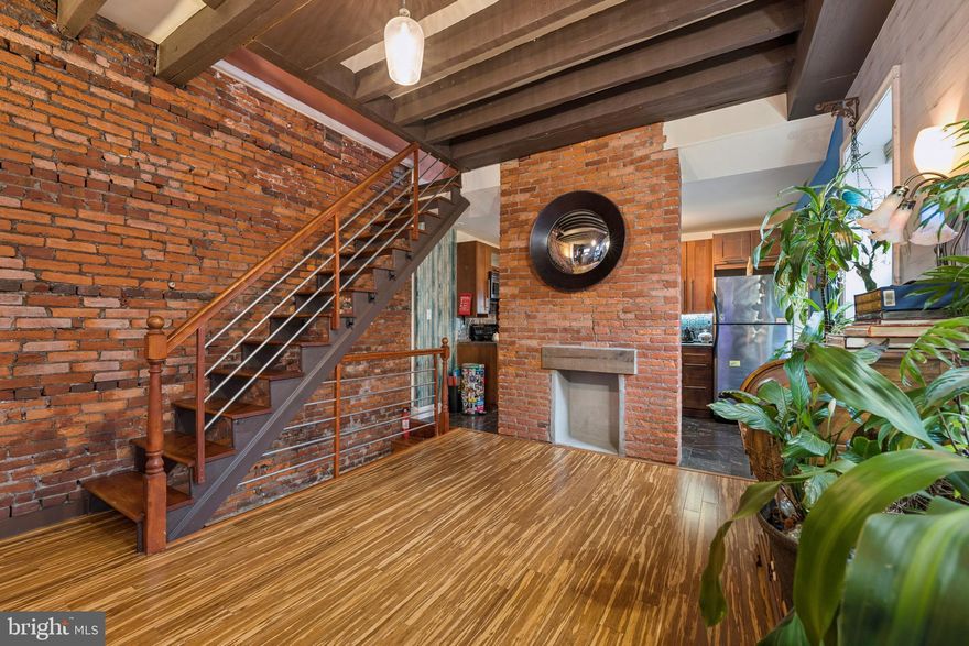 Welcome Home! Just a short stroll to all the shops, restaurants, and neighborhood favorites along Fairmount Avenue, this beautifully updated 3-bedroom, 3-bath home offers something incredibly rare in the city — privacy, quiet, three outdoor spaces and two-car parking!
Set back from the street, the home welcomes you with a charming front porch featuring a stunning, one-of-a-kind mosaic art piece set into the exterior as you enter — an immediate hint that this property is truly special. Inside, the sun-filled living and dining areas are rich with character, showcasing exposed brick, original beams, tiger wood bamboo flooring, sconce lighting, soaring ceilings, and a decorative fireplace that anchors the space beautifully. With windows throughout, natural light pours in from every angle.
The kitchen blends style and function with marble floors, honed granite countertops, stainless steel appliances, abundant cabinetry, and a window overlooking the private backyard. Outside, enjoy a spacious patio and garden area perfect for grilling, entertaining, or creating a dedicated dog run — all complemented by the oversized driveway and gated storage.
Upstairs, original Douglas Fir floors run throughout the second level. The bright front bedroom features exposed brick details, while the rear bedroom — currently used as an office/ craft room — offers French doors, skyline views, and incredible natural light. A full bath and a convenient second-floor laundry area complete this level.
The third-floor primary suite is a true retreat, showcasing exposed beams and brick, abundant light, a spacious en-suite bath with jetted tub and separate shower, along with French doors leading to a Trex deck with breathtaking Center City skyline views. 
The fully finished lower level offers exceptional additional living space, including a full bedroom/flex room, custom storage, recessed lighting, and a beautifully finished third bath. As you enter the basement, a second custom mosaic adds another artistic touch, reinforcing the unique character woven throughout the home. With a French drain, vapor barrier, and spray foam insulation, this level feels comfortable and fully integrated.
A rare blend of architectural charm, artistic detail, thoughtful updates, outdoor space, parking, and skyline views — all in one of Philadelphia’s most vibrant neighborhoods! The best of all worlds - in the city but never have to struggle for parking or privacy.