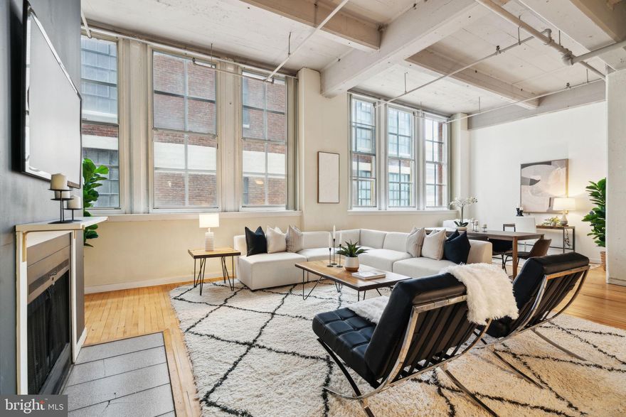 Here’s your opportunity to own a truly unique and spacious end-unit loft in one of Philadelphia’s most vibrant neighborhoods. This character-filled condo boasts soaring 12-foot ceilings, eight oversized windows, a working fireplace, and sleek hardwood floors throughout.

The thoughtfully designed kitchen features a pass-through layout with plenty of counter space, opening up to a flexible and expansive living area—perfect for a dining table, cozy living room setup, and even a home office or den.

The generously sized bedroom area includes a massive walk-in closet, while the full bathroom offers the convenience of in-unit laundry with a washer and dryer. Major systems have been recently updated, including the HVAC and hot water heater.

This pet friendly building features a brand-new communal roof deck with stunning 360-degree city views, a recently installed roof, and a convenient passenger elevator for easy access.

You’ll love the unbeatable location—walk to City Hall in under 10 minutes, or catch the Broad Street Line just a few blocks away. Cyclists will appreciate nearby bike lanes on 13th Street and Spring Garden Street. The Rail Park is less than two blocks away.

Enjoy some of Philly’s best dining and nightlife just around the corner: Café Lift, Prohibition Taproom, La Chinesca, Elixr, Union Transfer, Underground Arts, Love City Brewery, and so much more. Everyday conveniences like Giant, Trader Joe’s, and Reading Terminal Market are also just minutes away.

Don't miss your chance to own this exceptional space in the heart of the city—schedule your showing today!