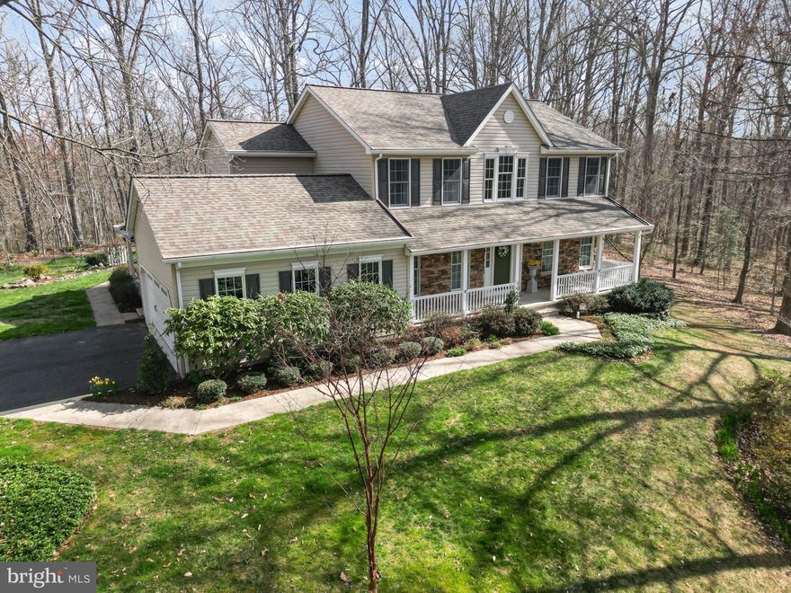 Welcome to your private retreat in the desirable community of St. Anne! This beautiful custom-built 4-bedroom, 2.5-bath colonial is nestled on just over 11 acres of wooded, picturesque, park-like serenity. The beautifully landscaped property boasts extensive perennial gardens, a naturalized fish pond, landscape lighting, and a natural stone patio, creating an enchanting outdoor oasis. Enjoy peaceful mornings or evening gatherings on the maintenance-free 17’ x 18’ deck or relax on the charming covered front and side porches while taking in the tranquil natural beauty.  A charming 16’ x 10’ shed offers versatile use as storage, a potting shed, or even a playhouse.   
Step inside to a dramatic two-story foyer that sets the tone for this elegant home. The spacious living room features french doors leading to the inviting family room, which boasts built in bookcases and is highlighted by a stunning stacked stone fireplace—perfect for cozy gatherings. The gourmet kitchen features a walk-in storage pantry and butler’s pantry, seamlessly flowing into the spacious dining room, ideal for hosting memorable dinners.
A huge main level office/hobby/play room with a separate side entrance with covered porch offers endless possibilities—perfect for remote work, creative pursuits, or even a private guest space. The spacious primary suite is a true retreat, featuring a recently renovated spa-like bath with dual sinks, a free-standing soaking tub, and a separate shower for ultimate relaxation.
With spacious living areas, a thoughtfully designed floor plan, and captivating surroundings from every window, this exceptional property offers the perfect blend of luxury and tranquility.   And just when you think it can't get any better, take a stroll to the community's common area offering walking trails and access to Deer Creek!   This truly is a rare opportunity to own a slice of paradise while still being conveniently close to schools, restaurants, shopping, and parks—don’t miss your chance to make this dream home yours!
Updates:  Roof w/transferable warranty 2018, Composite Deck and Railings 2018,  50 gallon propane HWH 2017,  Well Pump 2016, Furnace 2015