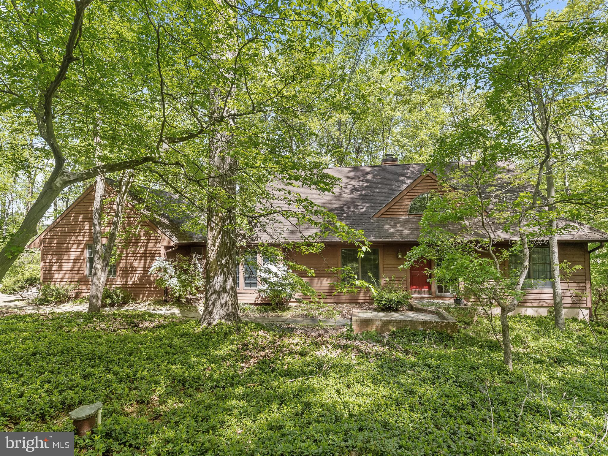 Escape to your own private sanctuary in this custom-built contemporary Cape Cod-inspired home nestled on 4.5 acres of natural wooded beauty. With cedar siding blending seamlessly into the surroundings, this stunning property offers the perfect blend of modern luxury and tranquil nature. Step onto the welcoming covered front porch and enter into the two-story ceiling foyer, where hardwood floors lead you to the inviting living room. Here, a wood-burning fireplace with a mantel sets a cozy ambiance, while French doors open to one of three decks overlooking the breathtaking rear grounds. The gourmet eat-in kitchen is a chef's delight, featuring stainless steel appliances, a decorative backsplash, and a sunny breakfast nook surrounded by windows that invite the outdoors in. The formal dining room provides an elegant space for festive gatherings. On the main level, you'll find the convenient primary bedroom suite, complete with a private deck, wood-burning fireplace, en suite bath with a jetted soaking tub, ceramic tile shower surround, and views of the woods. A spacious walk-in closet adds to the suite's allure. An entry room with ceramic tile floors and garage access makes grocery unloading a breeze, while a powder room completes the main level. Upstairs, three spacious bedrooms await, along with a full bath for added convenience. The lower level offers a cozy recreation room with plush carpeting, access to the third deck, and a brick surround wood-burning stove set upon a raised brick hearth. An adjacent room is perfect as your fitness haven, offering tranquil views of the surrounding woods. A bonus room on the lower level provides versatility as a studio, office, or craft room, offering privacy and inspiration for creative endeavors. Complete your DIY projects in the storage area, equipped with a workbench and laundry facilities. A full bath on this level adds to the home's functionality. With its serene setting, thoughtful design, and modern amenities, this exquisite home offers the ultimate retreat from the hustle and bustle of everyday life. Don't miss your chance to experience the beauty and tranquility of this remarkable property. Schedule your showing today!