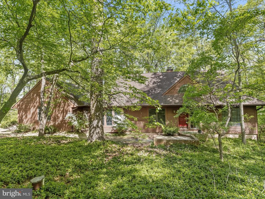 Escape to your own private sanctuary in this custom-built contemporary Cape Cod-inspired home nestled on 4.5 acres of natural wooded beauty. With cedar siding blending seamlessly into the surroundings, this stunning property offers the perfect blend of modern luxury and tranquil nature. Step onto the welcoming covered front porch and enter into the two-story ceiling foyer, where hardwood floors lead you to the inviting living room. Here, a wood-burning fireplace with a mantel sets a cozy ambiance, while French doors open to one of three decks overlooking the breathtaking rear grounds. The gourmet eat-in kitchen is a chef's delight, featuring stainless steel appliances, a decorative backsplash, and a sunny breakfast nook surrounded by windows that invite the outdoors in. The formal dining room provides an elegant space for festive gatherings. On the main level, you'll find the convenient primary bedroom suite, complete with a private deck, wood-burning fireplace, en suite bath with a jetted soaking tub, ceramic tile shower surround, and views of the woods. A spacious walk-in closet adds to the suite's allure. An entry room with ceramic tile floors and garage access makes grocery unloading a breeze, while a powder room completes the main level.  Upstairs, three spacious bedrooms await, along with a full bath for added convenience. The lower level offers a cozy recreation room with plush carpeting, access to the third deck, and a brick surround wood-burning stove set upon a raised brick hearth. An adjacent room is perfect as your fitness haven, offering tranquil views of the surrounding woods. A bonus room on the lower level provides versatility as a studio, office, or craft room, offering privacy and inspiration for creative endeavors. Complete your DIY projects in the storage area, equipped with a workbench and laundry facilities. A full bath on this level adds to the home's functionality.  With its serene setting, thoughtful design, and modern amenities, this exquisite home offers the ultimate retreat from the hustle and bustle of everyday life. Don't miss your chance to experience the beauty and tranquility of this remarkable property. Schedule your showing today!