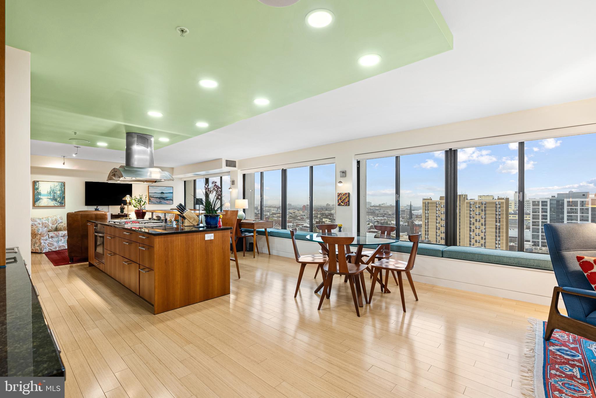 Experience luxury living in this stunning 2-bedroom, 2-bathroom condo, created by combining two units into a single, expansive residence in City View Condominiums. This spectacular residence is unlike anything else in the city. European influence resonates throughout this AIA architect designed space. Located on the 19th floor, enter foyer to a unit filled with beautiful natural light from three different exposures and 180 degrees of views with two private balconies. Attention to every detail from creating an entire hidden electrical and mechanical space for seamless customization to fully waterproofing the entire unit. Replete with high end finishes, this unit features bamboo flooring, an expansive wall of windows, plus smart systems for audio and visual throughout.
The custom-designed kitchen is a chef’s dream, featuring sleek Bulthaup cabinetry, a SubZero refrigerator with double drawer freezers, and a spacious island. Miele appliances include a five-burner gas cooktop, dishwasher, and GE Monogram hooded island extractor, while a dedicated dining area completes the space. A wet bar with an additional deep sink is a perfect complement for entertaining. The kitchen is flanked by two inviting seating areas, illuminated by Artemede lighting and ceiling spotlights perfect for showcasing art.
The primary suite is a serene retreat with floor-to-ceiling windows and a walk-in closet. Its spa-like ensuite bathroom boasts heated ceramic tile flooring, a stall shower, a double vanity, a bidet, and recessed lighting. The second bedroom features a Murphy bed and cabinetry, floor-to-ceiling windows, and access to a private balcony. The full hall bathroom contains a stall shower and stylish pendant lighting. This sale includes separate storage unit space and TWO CAR garage deeded parking.
Residents of this building enjoy a premier location with state-of-the-art amenities including a heated pool with a lush garden, bike room, fitness center, on-site laundry facilities, 24-hour security and guard for convenient package delivery. Easily entertain with a guest suite on-premises to rent for family and out-of-town guests. This pet-friendly building has everything you could possibly need plus more. Local conveniences such as Whole Foods, Target, world-renowned museums, incredible restaurants, and attractions are steps outside your door. Easy commuting to Center City via Septa bus or within walking distance to Rittenhouse Square. For an active lifestyle, take advantage of the building's own gym or enjoy walking, biking, and running along the river on Kelly Drive.