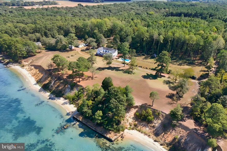 Welcome to 522 Felton Rd, Deltaville—an extraordinary house. The original house was built around 1800. This waterfront treasure has been extensively and thoughtfully renovated. There has also been extensive expansion of the modern living areas. Nestled on nearly 12 private acres with approximately 700+ feet of pristine sandy beach, this 5,000+ sq ft residence blends historic charm with luxurious upgrades. Inside, enjoy a chef’s kitchen with premium appliances, heart-pine floors, and elegant gathering spaces. The primary suite features dual walk-in closets, a spa bath, and an 800 sq ft balcony with sweeping views of the Rappahannock River and Chesapeake Bay, where eagles and dolphins are frequent visitors. Outdoors, relax by the private pool, entertain on the waterfront, or stroll the secluded shoreline. A rare opportunity to own a piece of history, offering unmatched privacy, beauty, and comfort in the boating capital of the Chesapeake.