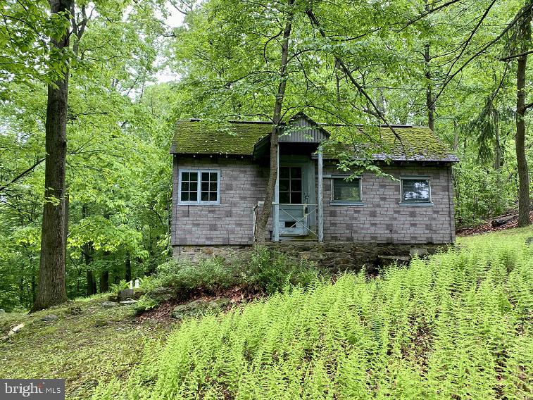 Calling ambitious weekend getaway seekers and tiny home enthusiasts.  Bring your enthusiasm & vision and construction skillset to renovate this circa 1950, 2 room, 240 +/- square foot Bungalow which served as a weekend retreat in decades past.  Enjoy awesome views of the rolling country side from this 3/4 acre lot located in the scenic Landis Store area.  An in ground septic system was installed in 1991 but has never been utilized.  A former well is also in place.  This property needs to be fully renovated.  Constructing a new home on this attractive property is also a possibility.