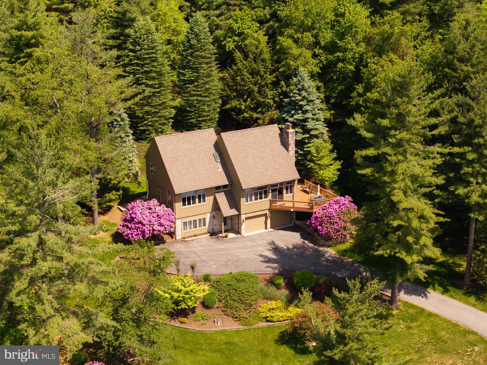 This home is warm and inviting from the moment you pull into the beautiful Glenfield subdivision. Offering three levels of living space, granite counter tops, hardwood flooring and a spacious first floor master suite. The large stone wood burning fireplace, makes a great place to gather with family and friends. The abundance of windows and sliders bring the beauty of the outside in during any season. If outside space is also important to you, this home has it covered. Boasting a wrap around Trex deck, large brick patio, two car attached garage and a storage shed. You are also just minutes away from the single slip dock that is included with this home. The location is another plus, just minutes to Wisp Ski Resort, grocery stores and restaurants. Call today to preview!