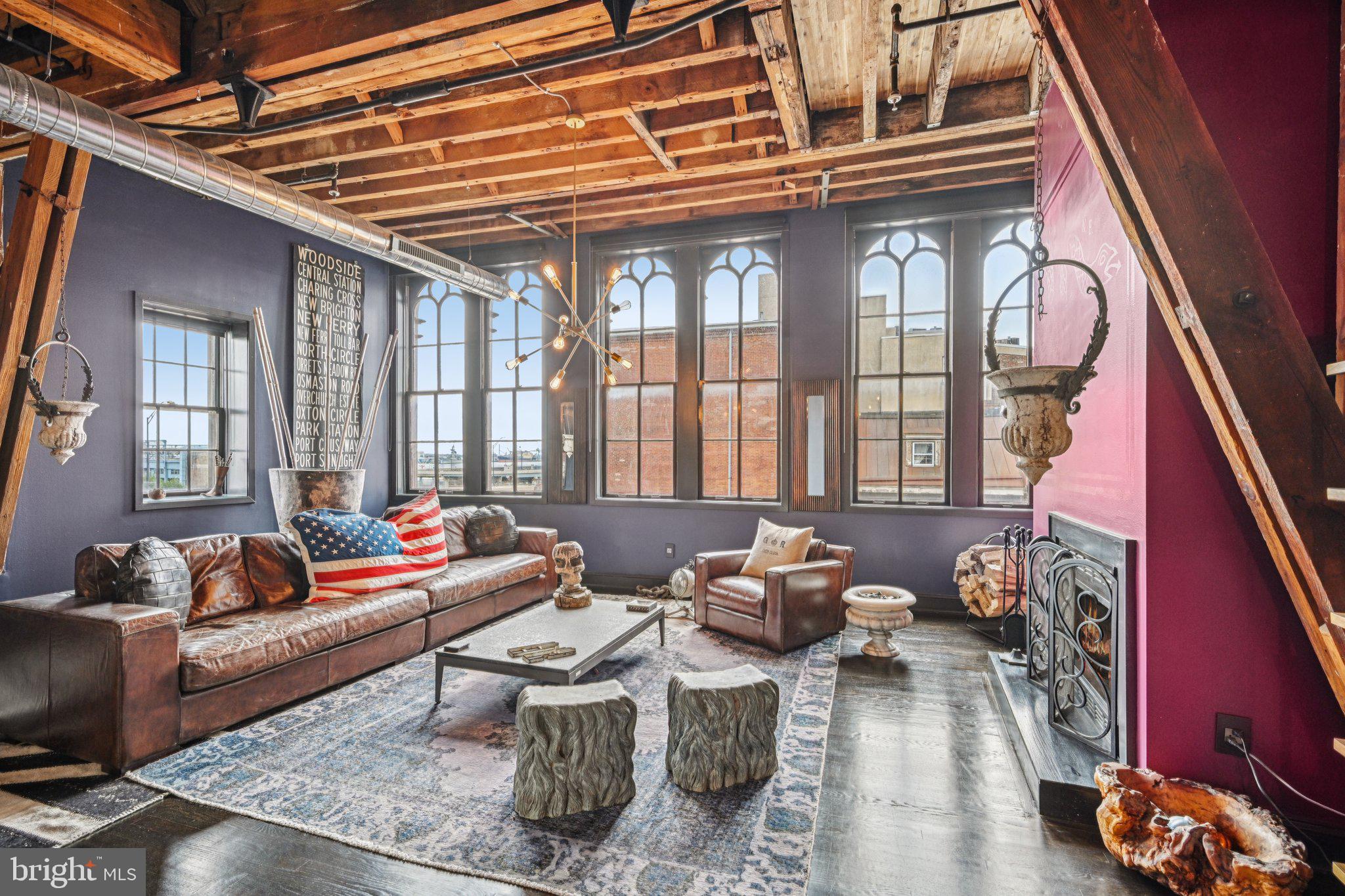 Discover historic charm and modern updates in this unique 1-bedroom corner condo featuring soaring 15' ceilings with exposed beams, hardwood floors, and a wood-burning fireplace. The spacious living area showcases exposed brick and original 19th-century arched windows, enhanced by custom Bronze Studio Star ceiling lights. The remodeled kitchen includes stainless steel appliances, updated cabinetry, a wine fridge, and a striking chandelier. The half bath features a refurbished 1930s brass and milk glass dental sink, while the bedroom offers a chandelier and a custom full bath with a cast iron pedestal sink crafted from an 1880s New Orleans architectural column. A new HVAC system ensures year-round comfort. Schedule your showing today!