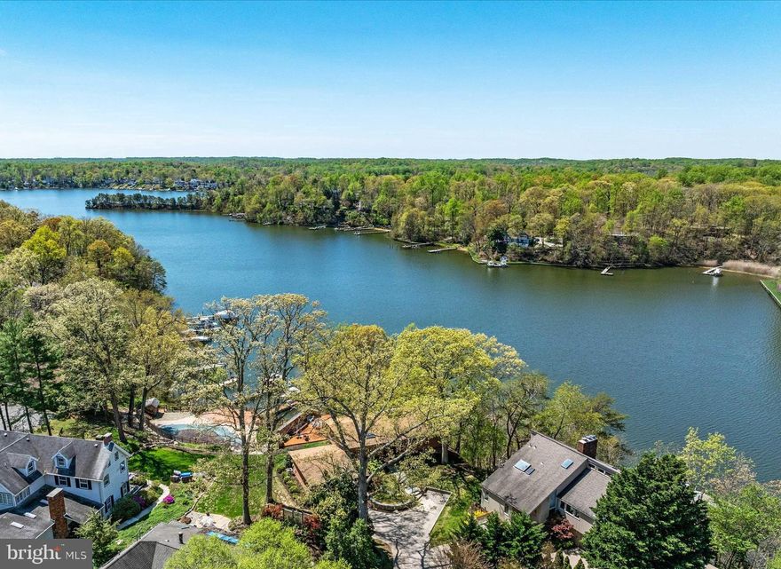 Bright, airy waterfront deck home in Broadview Estates with sweeping western views across Broad Creek. The property includes a tram, private pier, 2 deepwater boat slips (40 feet and 50 feet), water, power, and small boat lift.  The home features a main-level primary bedroom with ample closet space and ensuite bath; open kitchen, living, and dining area with a large brick wood-burning fireplace; vaulted cedar ceilings; and walls of windows to bring the outside in.  The western-facing deck is ideal for dining, entertaining, and enjoying river views.  The lower-level offers two additional bedrooms, family room with modern wood-burning stove, second full bath, laundry and utility room, and an enormous custom walk-in closet. The almost 600 square foot attached 2-car garage includes plenty of additional storage and work space.  This home has public water, sewer, and gas. Beautifully maintained; recent improvements include LVP floors on main level (2024), carpets in lower level bedrooms (2024), heat pump (2023), and GE Refrigerator (2023). This home has everything you could want:  a deepwater pier, amazing sunset water views, main-floor primary bedroom, and over-sized attached garage. The driveway is shared with 373 and 375 Broadview Ln. This popular waterfront neighborhood has a community pier, boat launch area, walking paths, and sidewalks - all within easy access to DC, Baltimore, and the Eastern Shore. Contact listing agent for private tour.