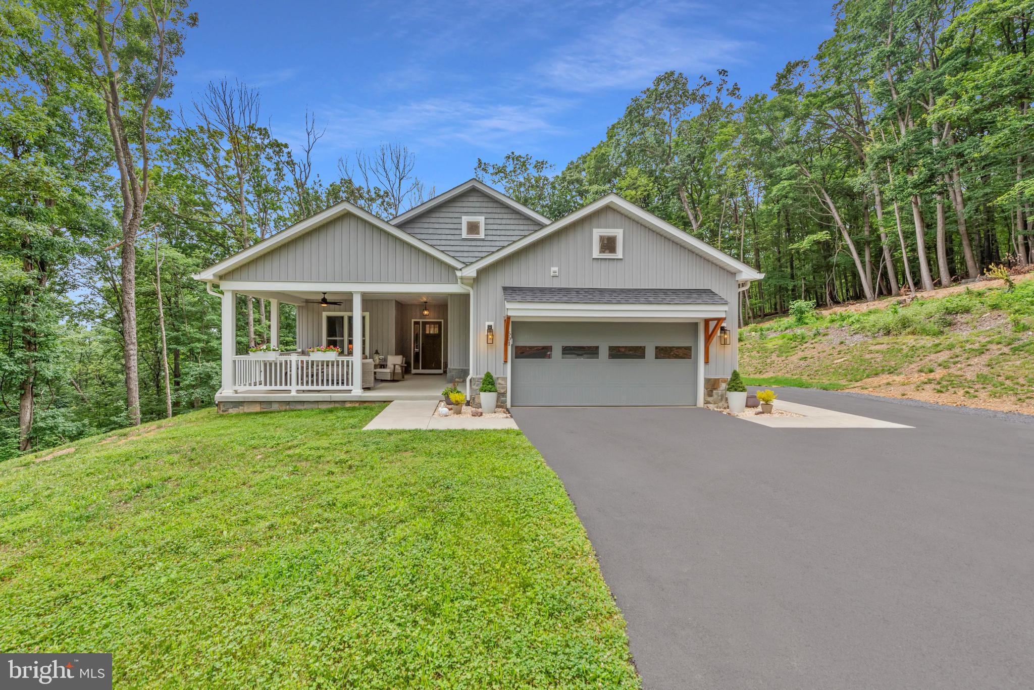 Prepare to be captivated by the beauty and tranquility of this exceptional custom-built home, nestled on 20.10 acres with breathtaking mountain views. Offering desirable one-level living, this nearly new (under 3 years old) home boasts a gorgeous covered porch and an expansive deck perfect for savoring the stunning surroundings. Step inside to discover a meticulously designed open-plan layout, ideal for both entertaining and everyday living. The gourmet chef's kitchen is a true centerpiece, featuring high-end appliances, striking quartzite countertops, and a substantial island. Adjacent to the kitchen, the dining area comfortably accommodates gatherings of six or more, flowing seamlessly into a welcoming living area anchored by a beautiful fireplace. Retreat to the luxurious and light-filled primary suite, complete with a spa-like bathroom featuring a walk-in shower. Two additional well-appointed bedrooms share a gorgeous second bathroom. The expansive unfinished basement, mirroring the 2,175 sq. ft. of the main level, presents a blank canvas with a walkout entrance and rough-in plumbing for a future bathroom – envision endless possibilities for a recreation room, home office, fitness room, media center, or additional bedrooms. Outside, choose between the impressive covered front porch and the rear full-width deck, offering picturesque views of the surrounding trees and distant mountain range – an idyllic setting for al fresco dining. This remarkable property offers a rare opportunity to embrace a peaceful mountain lifestyle without sacrificing modern comfort and convenience. With 20+ acres available, the new owner could potentially subdivide the property to create an additional homesite. Don't miss this spectacular property!
