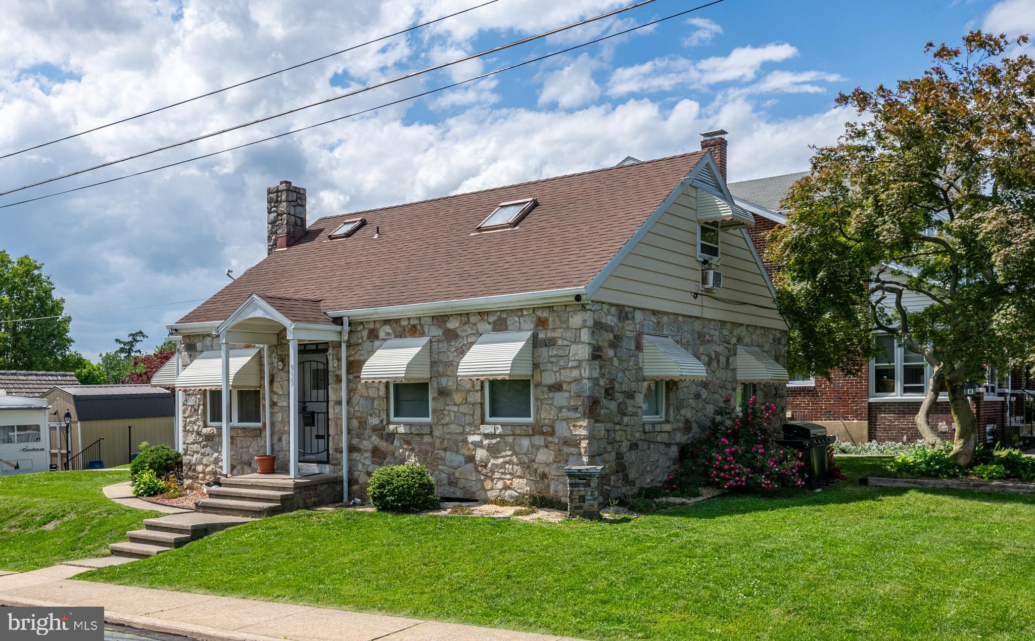 This charming, well-kept stone Cape Cod offers a perfect blend of comfort, character, and curb appeal. Situated on a corner lot in Laureldale with mature landscaping, this home has a warm and inviting layout with three bedrooms and two and a half baths. Main level consists of a large living room, functional kitchen, two comfortably sized bedrooms, and full bath. Upstairs, you will find the primary bedroom suite with its own full bath and skylights that fill the space with a lot of natural light. Partially finished basement provides additional living space, ideal for a family room, office, or hobby area. There is also plenty of storage space and a convenient half bath. Outside, enjoy a side porch, a detached one car garage with carport, and of off street parking for six car. Located in Muhlenberg schools, this is an affordable, move-in ready home you won’t want to miss.