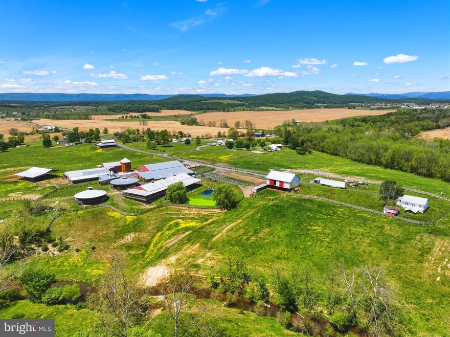 Welcome to an extraordinary opportunity to own over 277+ acres of breathtaking countryside offering endless possibilities for equestrian, agricultural, business, and event use. This remarkable property combines multiple parcels to create a truly one-of-a-kind retreat featuring stunning mountain views, gorgeous rolling pastureland, and a beautiful creek flowing throughout the property. Fully fenced and thoughtfully designed, the land is ideal for horses, cattle, recreation, or creating the ultimate destination property.

Equestrian enthusiasts will appreciate the impressive setup featuring multiple barns, a horse barn with 52 stalls, round pens, and an arena already in place. The property also includes an event space, operating office, living quarters, and an additional home ready to be finished into even more living space or guest accommodations. Several ponds add to the beauty and functionality of the land while creating peaceful scenic settings throughout the property.

Whether you envision a premier equestrian facility, wedding or event venue, working farm, retreat center, or private estate, this incredible property offers the space, infrastructure, and natural beauty to bring your vision to life. Rarely does a property of this size and versatility become available with so much already established and ready for its next chapter.