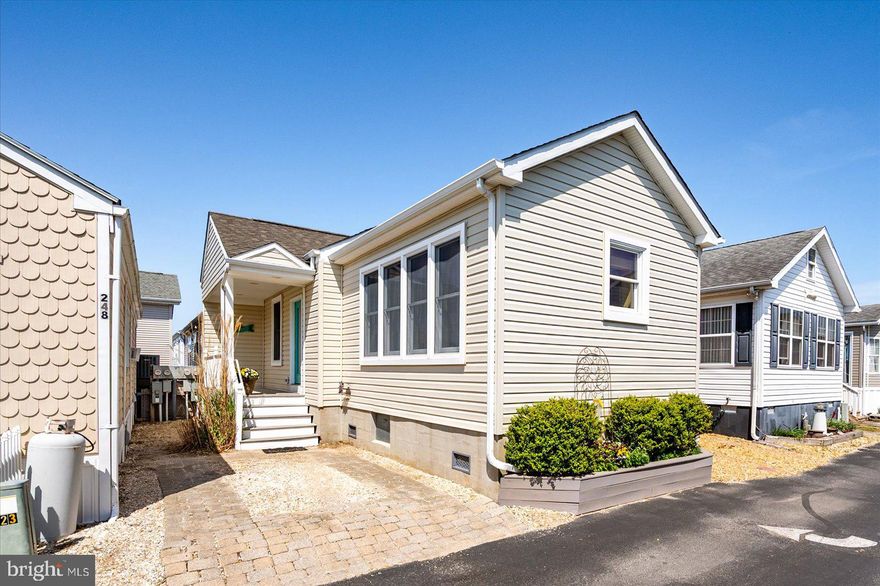 Welcome to the Isle of Wight Neighborhood! This beautifully crafted, custom-built detached 2-bedroom, 2-bathroom single-family home offers the perfect blend of comfort, quality, and convenience—just three blocks from the beach and boardwalk. Enjoy a low $75/month HOA fee that covers water, sewer, trash pickup, road maintenance, lighting, management, and ground upkeep.  Designed to last, the home features 6” exterior walls, Andersen windows, a high crawlspace, and porcelain flooring throughout. Dimmer lights add ambiance in the living room, master bedroom, and porch. The kitchen is a chef’s dream, complete with granite countertops, custom wood cabinetry, under-cabinet lighting, a built-in microwave, and stove. The spacious master suite includes an ensuite bath with a walk-in shower. Additional updates include a new heat pump (2024), a refrigerator (2023), and upgraded comfort-height toilets. With close proximity to restaurants, amusements, shopping, and entertainment, this property is the ultimate beachside getaway or year-round residence.