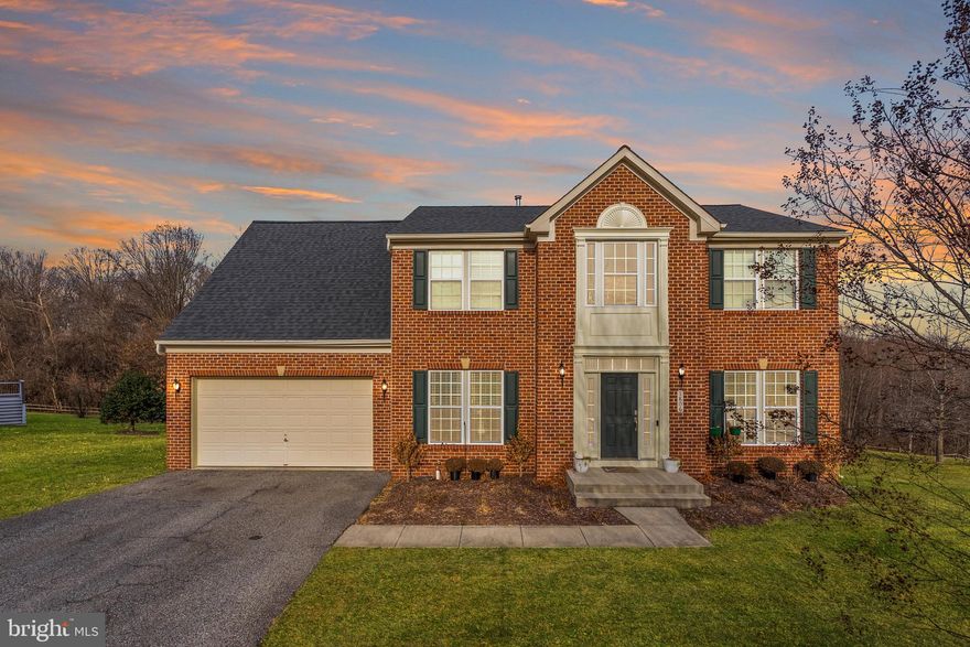 OPEN SUN 1-3 PM! Set on a sprawling 1.45 Acres, this beautiful 3,748 SF brick colonial is ready for you to move right in. Some standout features of the home include: solid oak floors on the main level, main level bedroom with en-suite full bathroom, finished basement, fully remodeled kitchen (2020), soaring ceilings, luxurious Primary Suite, and attached 2-car garage. 

 ● MAIN LEVEL: Enter into a grand, 2-story foyer flooded with natural light and enjoy an easy flowing floor plan on the main level. The kitchen-dining-living rooms are all connected at the back of the home, making a perfect space for socializing and entertaining. The entire rear wall of the home is windows, bringing a peaceful serenity to the space overlooking the large lot backing to woods. Featuring quartz countertops, stainless appliances, newer cabinetry, a peninsula with seating and a proper pantry, this kitchen is a chef’s dream! In addition to the bedroom with en-suite full bath, the main level also features a flexible front room (currently used as office but can be a formal living room or formal dining room), access to the large 2-car garage, access to the newly finished basement, and an opportunity to add a rear deck off the dining area. 

 ● The UPPER LEVEL features a beautiful primary suite along with 3 ample-sized bedrooms and a full hallway bath. The Primary Suite receives tons of natural light through large windows and also offers peaceful views of the rear lot & woods. The en-suite bathroom features a large soaking tub with separate spacious shower and dual sinks. The extra-large walk-in closet is a real cherry on top! 

 ● LOWER LEVEL: The current owners recently finished the walk-out basement, adding an additional  1,200 finished SF of living space - including a large rec room area, a half bathroom, and a bonus room (office, gym, media room, guest room…). 

 ● SYSTEMS: Almost all systems and appliances have been updated recently: Roof 2018, HVAC 2017, Kitchen appliances 2020 (except microwave 2024), W/D est. 2020. 

 ● COMMUNITY: The HOA Community, Vistas at Gallahan, was built in 2009 by Ryan Homes. The total monthly community fee is $165, which includes both HOA and Deferred Water & Sewer payments. The HOA portion is $56.67/months (payable quarterly) and covers all community landscaping, grounds improvement and professional management by local firm, H&E Management Associates. The deferred water & sewer portion is $108.37/mo (payable annually to Gallahan Farm Water & Sewer) and has only 7 years remaining.
